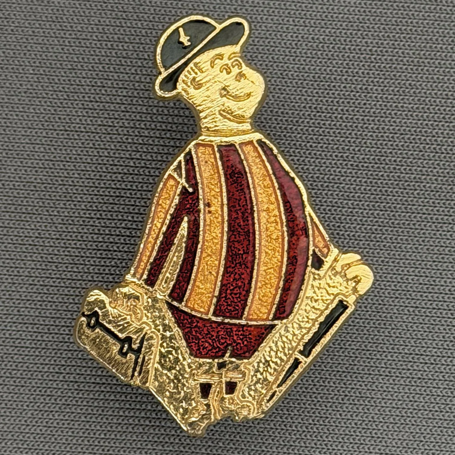 Reference Number: BCGEN007
Size: H 31.2 mm x W 21.1 mm
Pin Type: Metal Clutch
Plating: Gold
Value: £20
Manufacturer: Rojack Stamping
Comments: Classic City Gent Badge, Claret Shorts. Mid 1980s