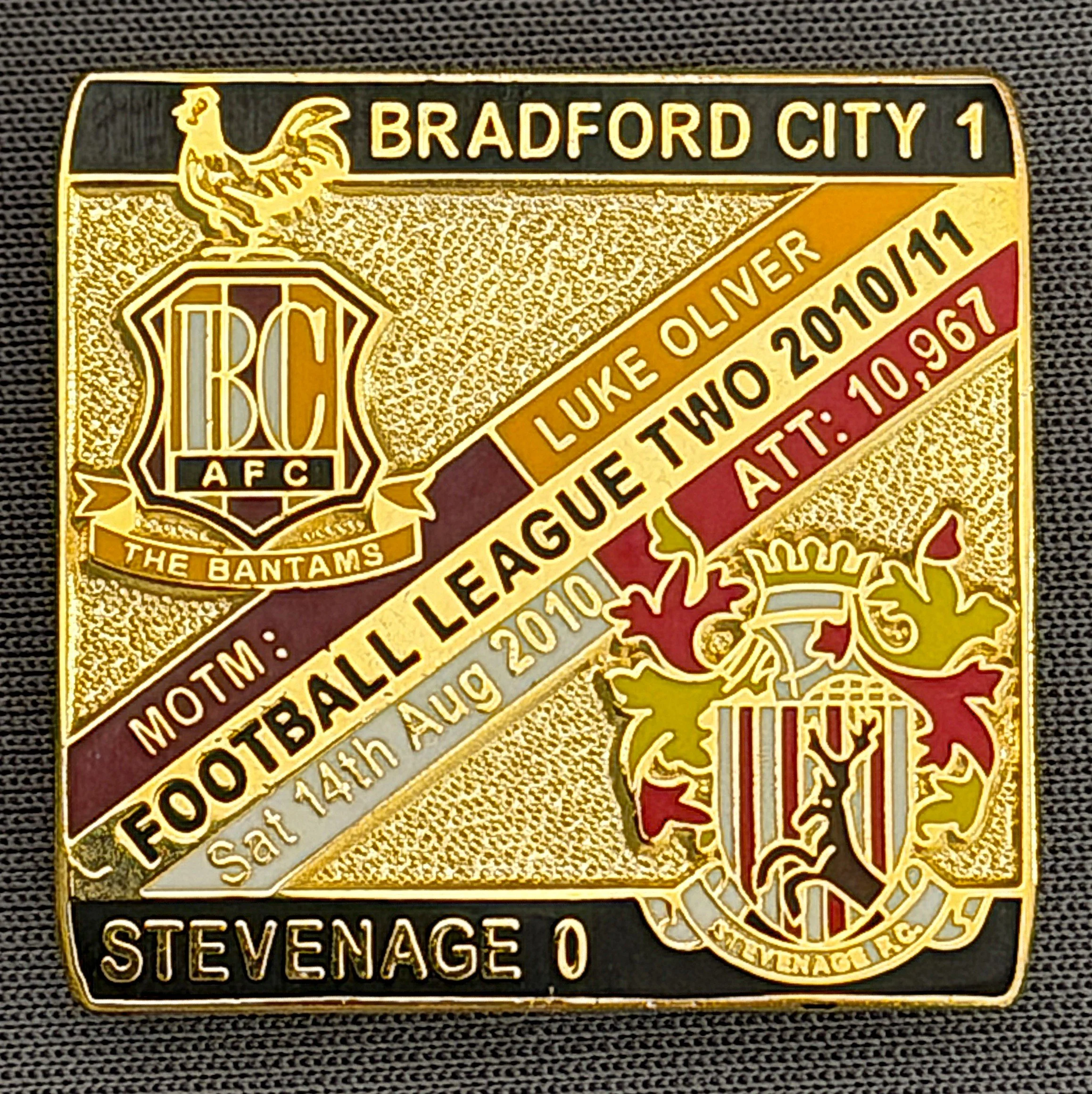 Reference Number: BCFIX047
Size: H 28.3 mm x W 29.3 mm
Pin Type: Brooch Pin
Plating: Gold
Value: £8
Manufacturer: Bradford City Badges
Comments: Bradford City v Stevenage  2010/11 Limited Edition 100 Badges