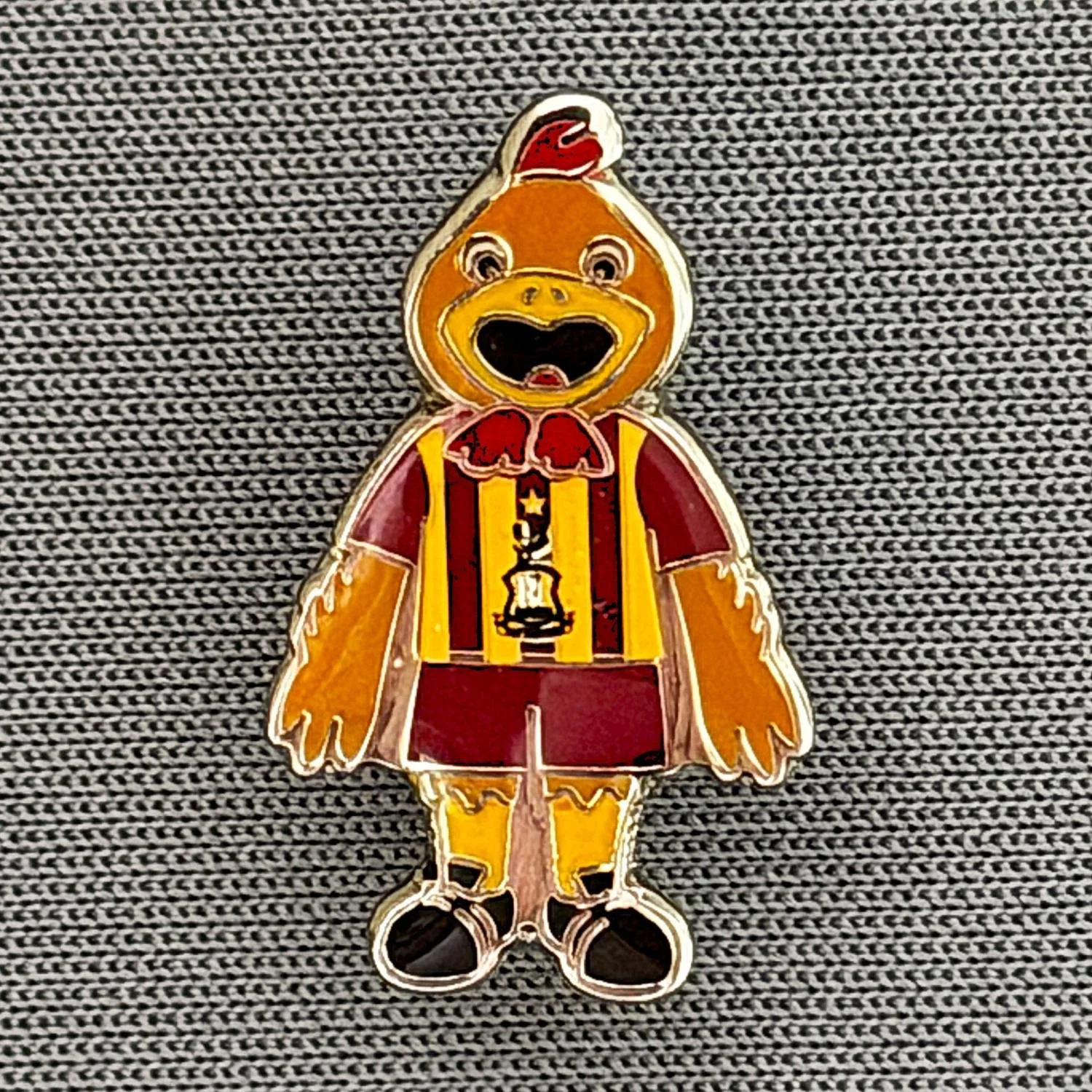 Reference Number: BCBAN070
Size: H 20.6 mm x W 12 mm
Pin Type: Metal Clutch
Plating: Silver
Value: £6
Manufacturer: Bradford City Shop
Comments: Small Billy Bantam