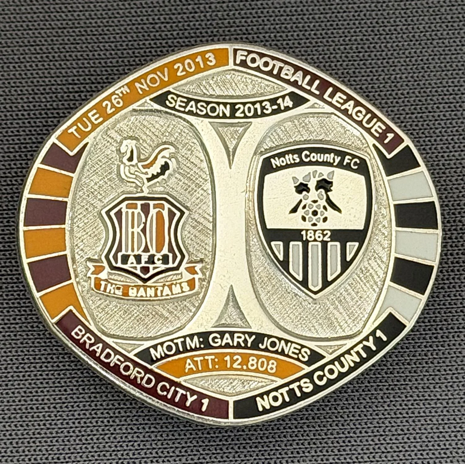 Reference Number: BCFIX216
Size: H 26.3 mm x W 28.9 mm
Pin Type: Brooch Pin
Plating: Silver
Value: £10
Manufacturer: Bradford City Badges
Comments: Bradford City v Notts County  2013/14 Limited Edition 10 Badges (Silver Version)