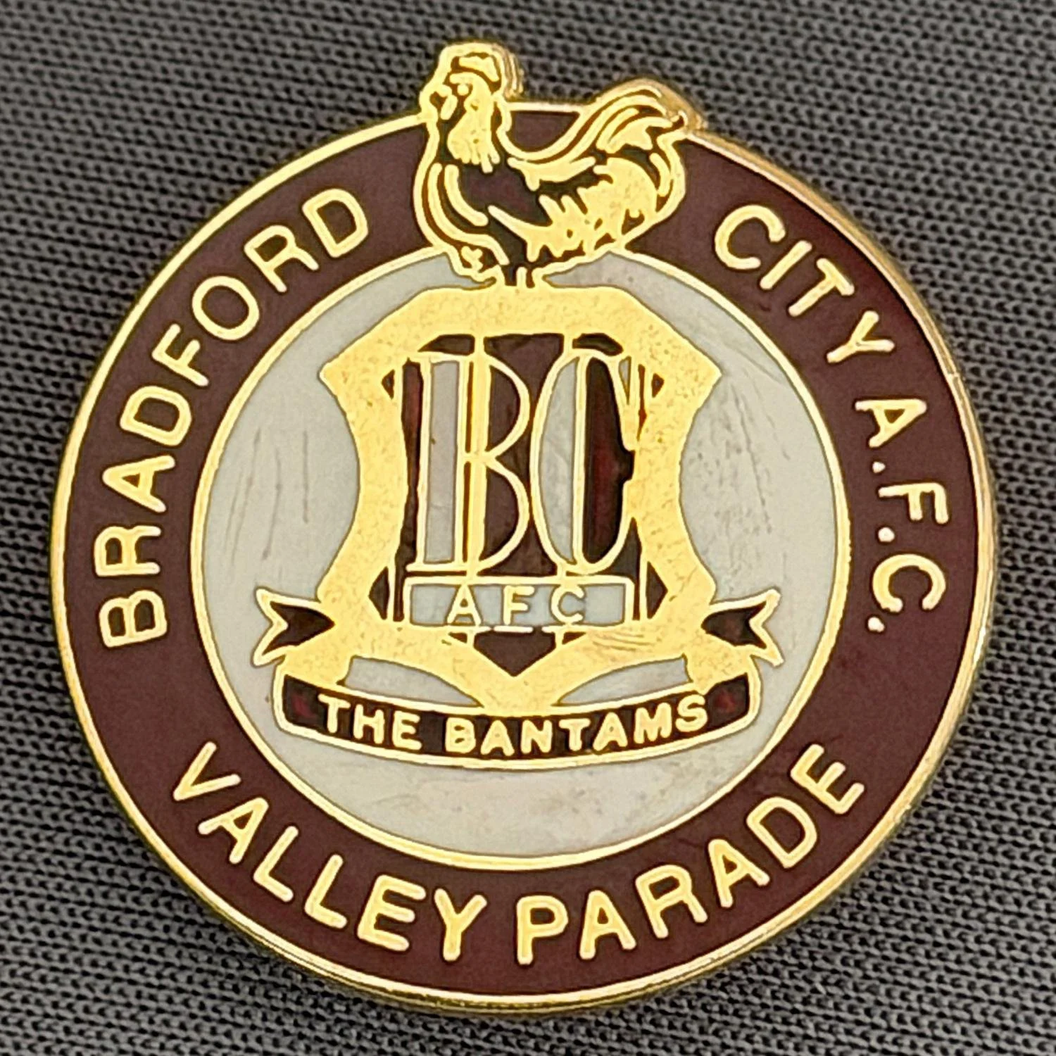 Reference Number: BCC&L009
Size: H 25.3 mm x W 24  mm
Pin Type: Brooch Pin
Plating: Gold
Value: £8
Manufacturer: Unknown
Comments: Claret Valley Parade, City logo