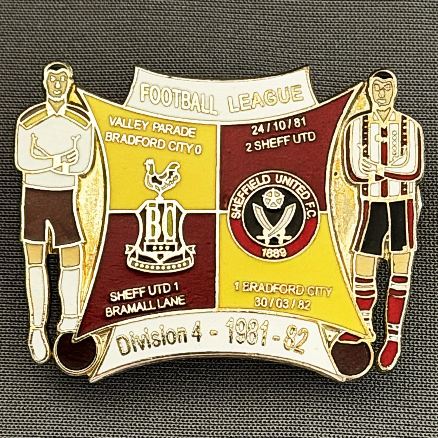 Reference Number: BCOFIX051
Size: H 30.1 mm x W 38 mm
Pin Type: Double Metal Clutch
Plating: Silver
Value: £8
Manufacturer: Unknown
Comments: Bradford City v Sheffield United 1981/82 Division 4, Amber & Claret Version