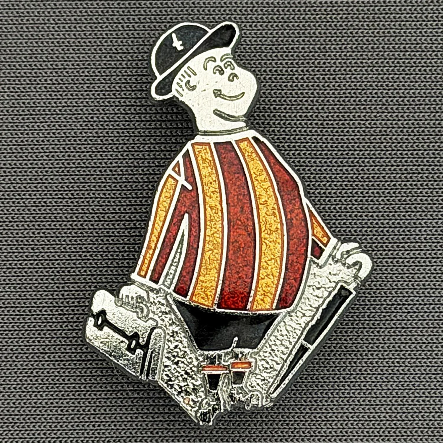 Reference Number: BCGEN003
Size: H 31.2 mm x W 21.1 mm
Pin Type: Brooch Pin
Plating: Silver
Value: £15
Manufacturer: Rojack Stamping
Comments: Classic City Gent Badge, Black Shorts. Mid 1980s.
