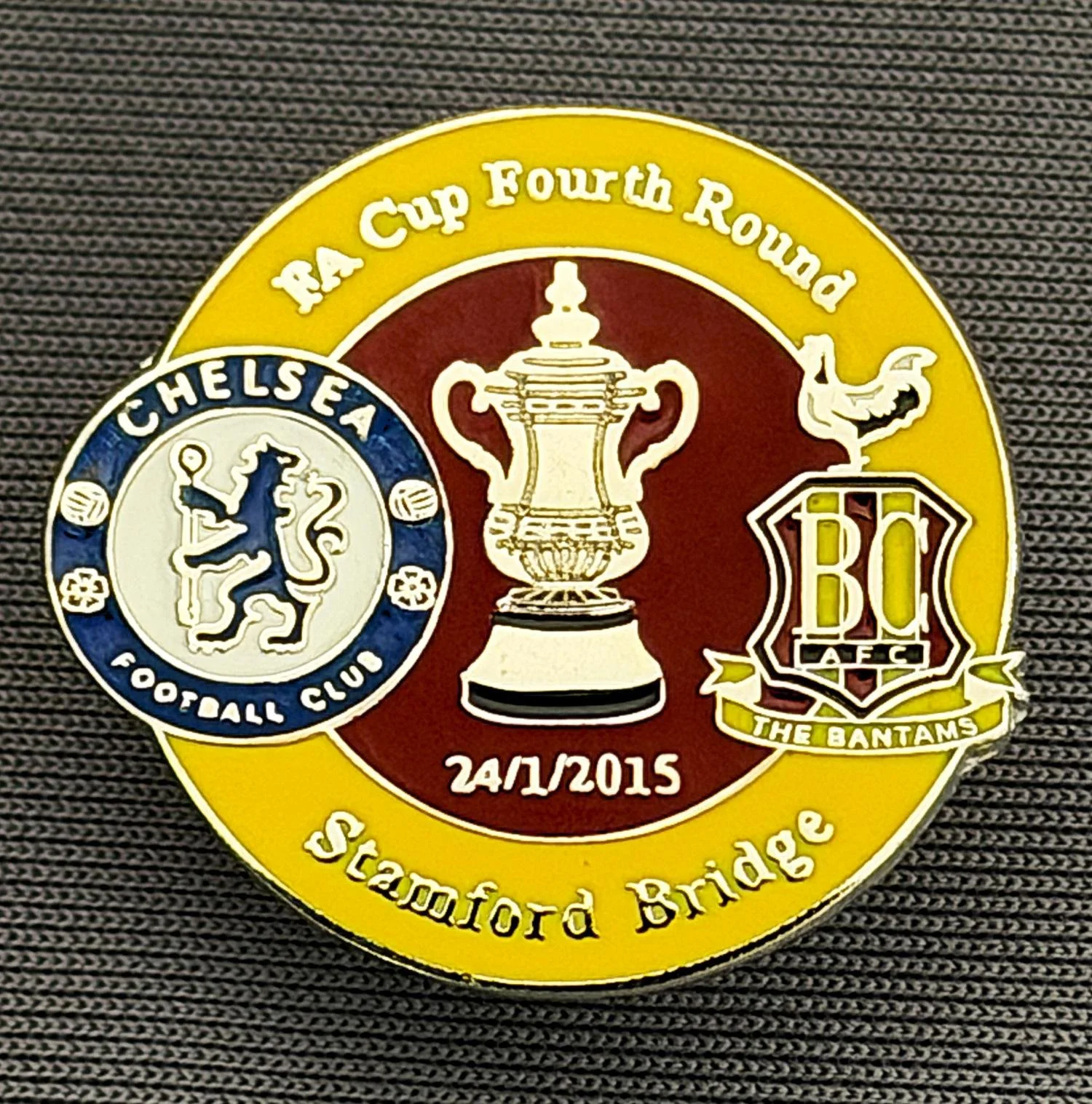 Reference Number: BCFAC087
Size: H 23.3 mm x W 25.3 mm
Pin Type: Metal Clutch
Plating: Silver
Value: £4
Manufacturer: Dan Lloyd
Comments: F.A. Cup Fourth Round 2014/15, Away v Chelsea, Amber & Claret Version