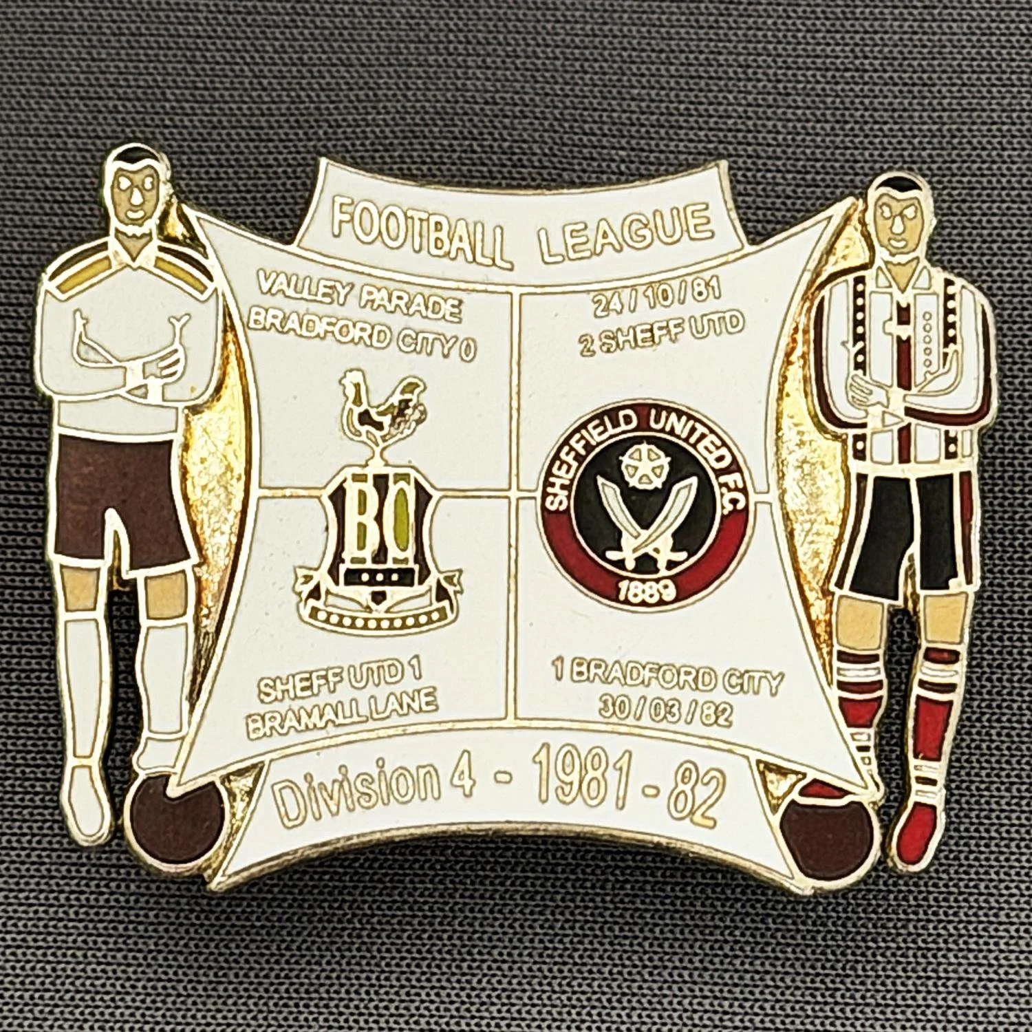 Reference Number: BCOFIX054
Size: H 30.1 mm x W 38 mm
Pin Type: Double Metal Clutch
Plating: Silver
Value: £8
Manufacturer: Unknown
Comments: Bradford City v Sheffield United 1981/82 Division 4, White Version