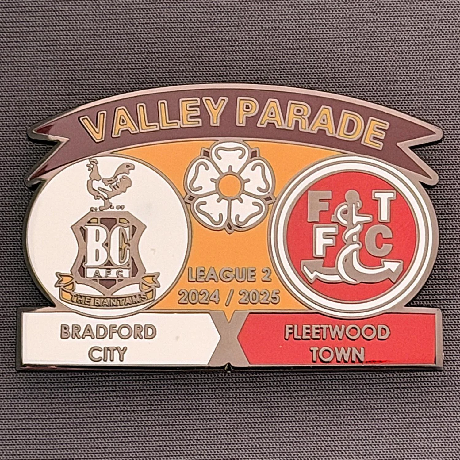 Reference Number: BCFIX415
Size: H 34.3 mm x W 50 mm
Pin Type: Brooch Pin
Plating: Black Nickel
Value: £5
Manufacturer: Unknown
Comments: Bradford City v Fleetwood Town 2024/25.