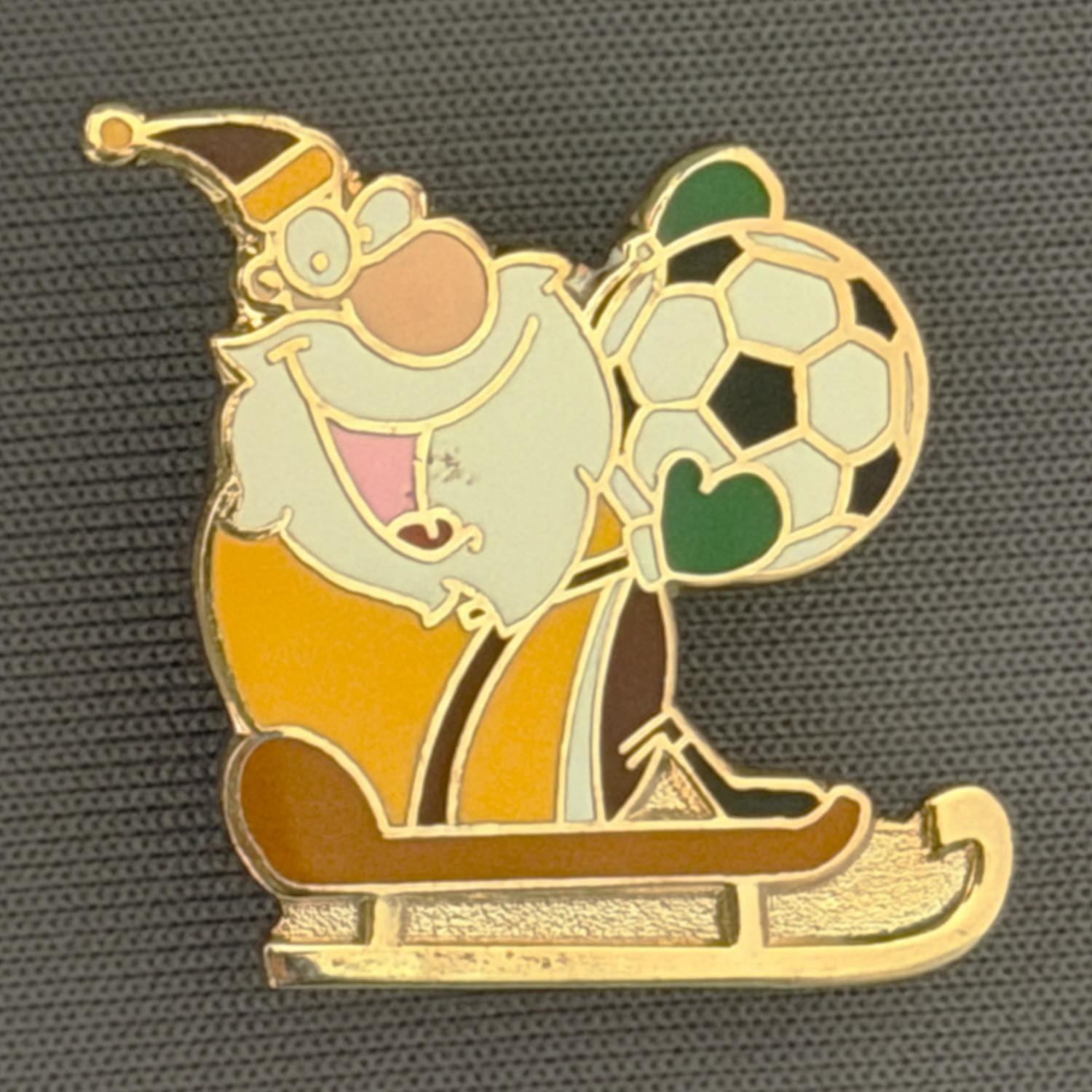 Reference Number: BCCTN049
Size: H 22.1 mm x W 27.1 mm
Pin Type: Double Plastic Clutch
Plating: Gold
Value: £6
Manufacturer: Unknown
Comments: City Santa Sleigh Football