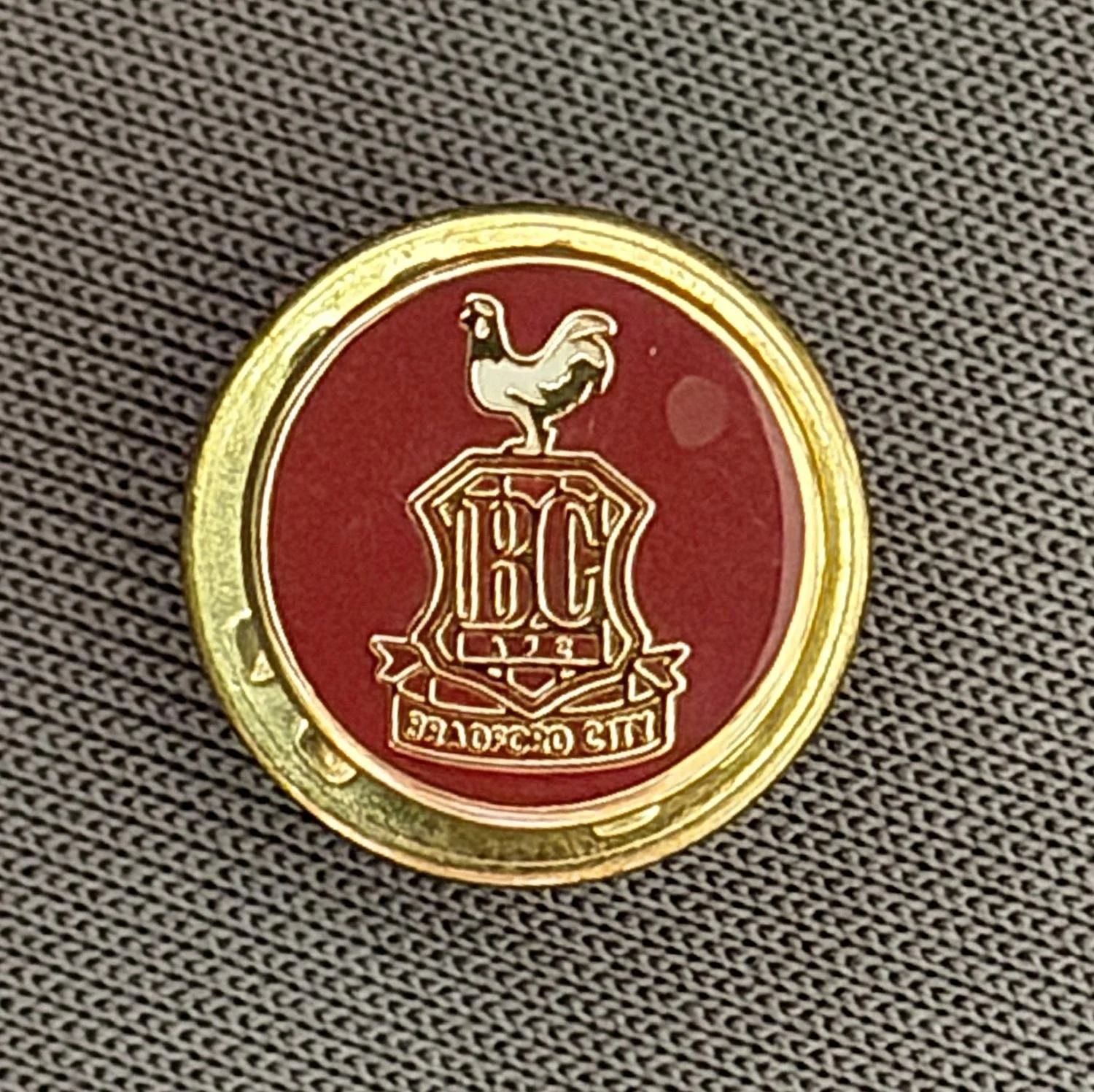 Reference Number: BCC&L034
Size: D 9.9 mm
Pin Type: Metal Clutch
Plating: Gold
Value: £8
Manufacturer: Unknown
Comments: Tiny Claret City Logo