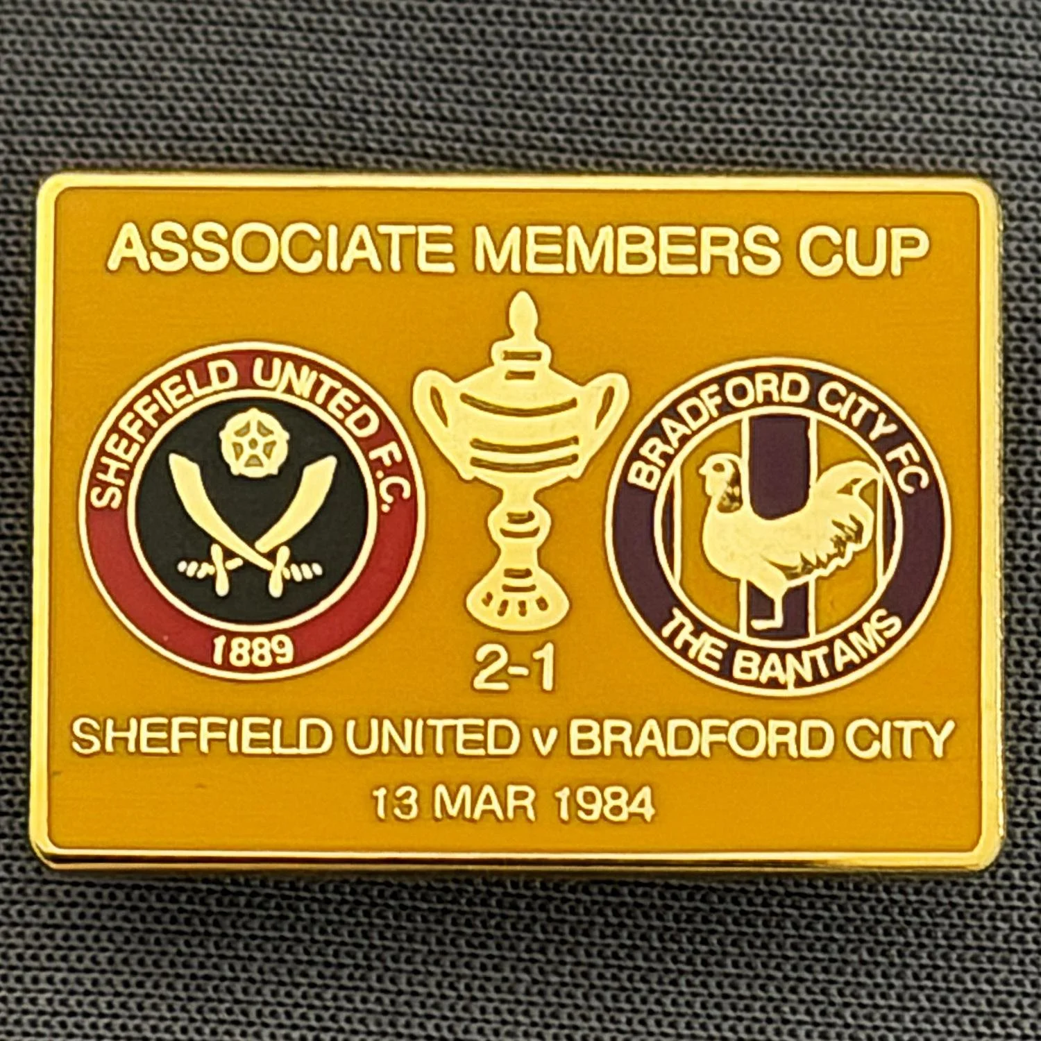 Reference Number: BCOFIX057
Size: H 18.9 mm x W 25.9 mm
Pin Type: Brooch Pin
Plating: Gold
Value: £6
Manufacturer: Unknown
Comments: Sheffield United v Bradford City Associate Members Cup 1984, Amber Version