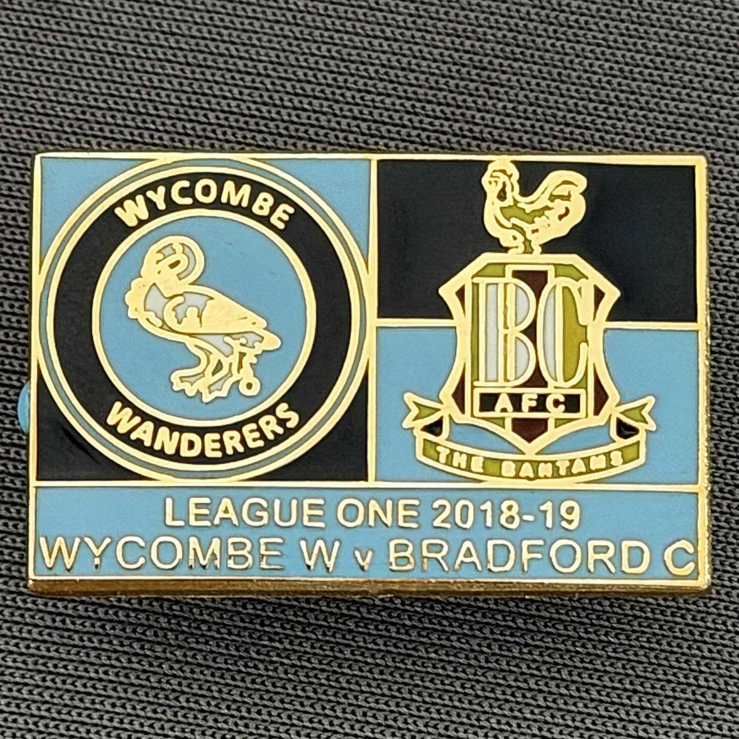 Reference Number: BCOFIX157
Size: H 17.3 mm x W 26.6 mm
Pin Type: Rubber Clutch
Plating: Gold
Value: £5
Manufacturer: Unknown
Comments: Wycombe Wanderers v Bradford City League One 2018/19 