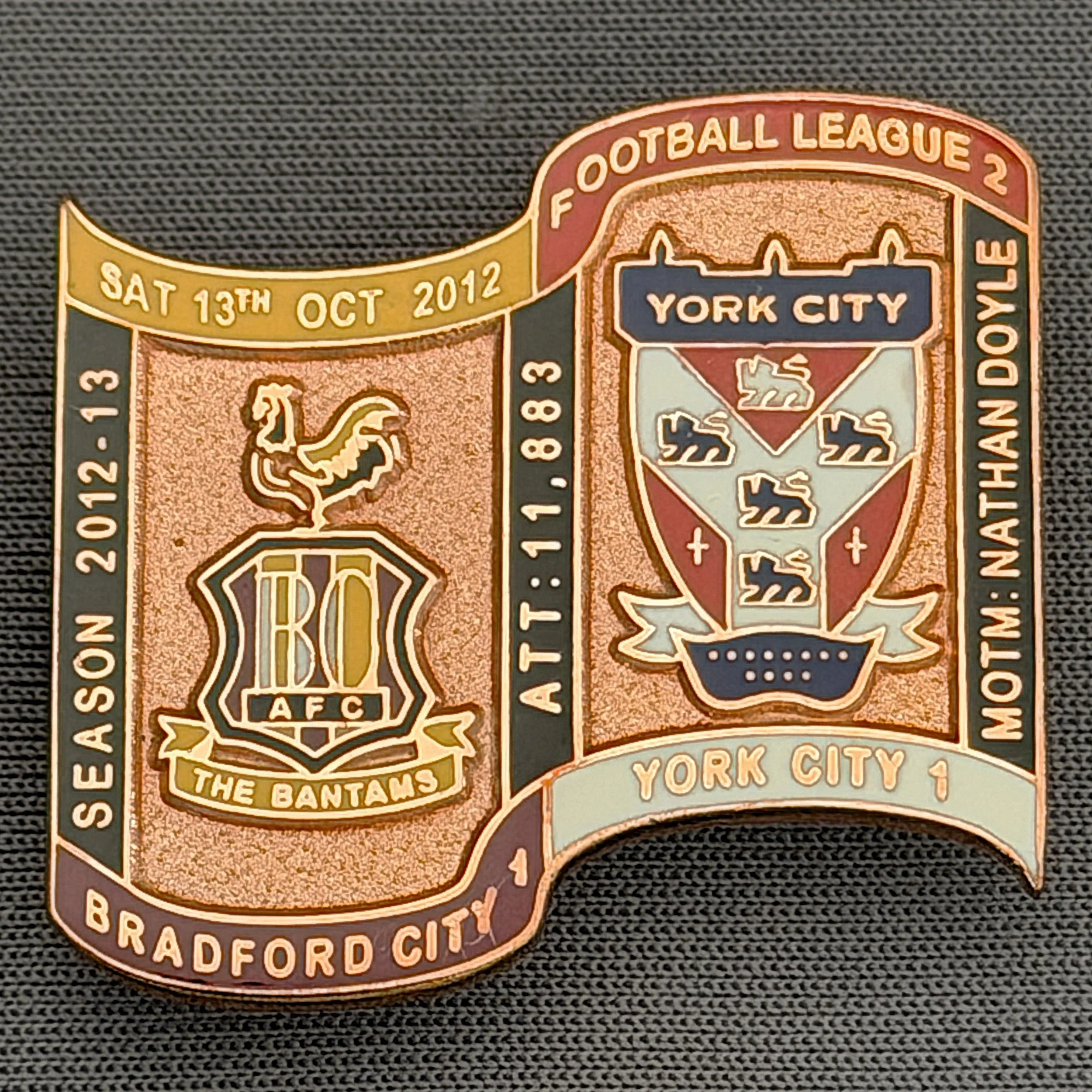 Reference Number: BCFIX167
Size: H 26.9 mm x W 29.2 mm
Pin Type: Brooch Pin
Plating: Copper
Value: £12
Manufacturer: Bradford City Badges
Comments: Bradford City v York City  2012/13 Limited Edition 1 Badge (Copper Version)