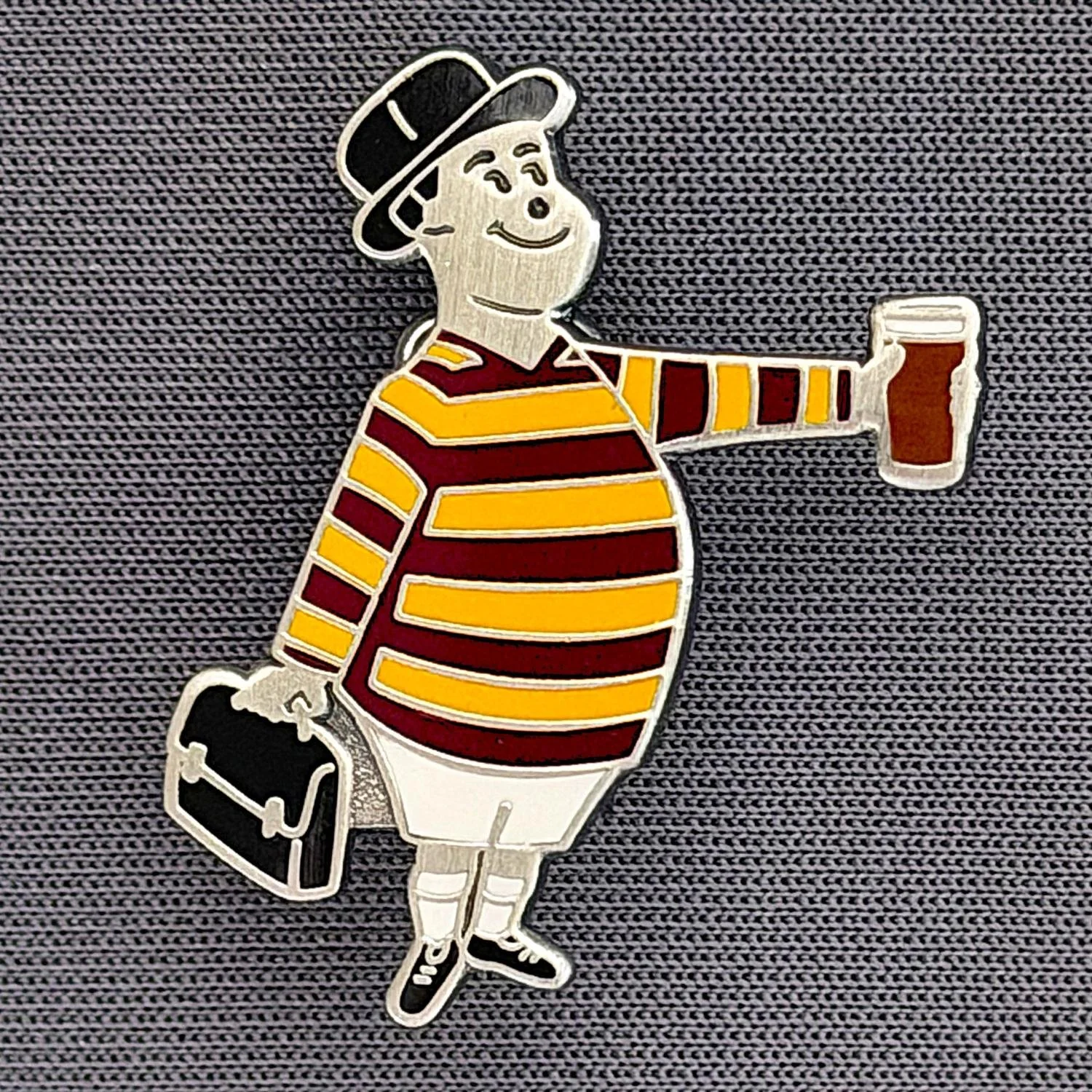 Reference Number: BCGEN078
Size: H 28.8 mm x W 20.9 mm
Pin Type: Brooch Pin
Plating: Antique Silver
Value: £20
Manufacturer: Bradford City Badges
Comments: City Gent Beer, Black Briefcase. One Off Badge.
