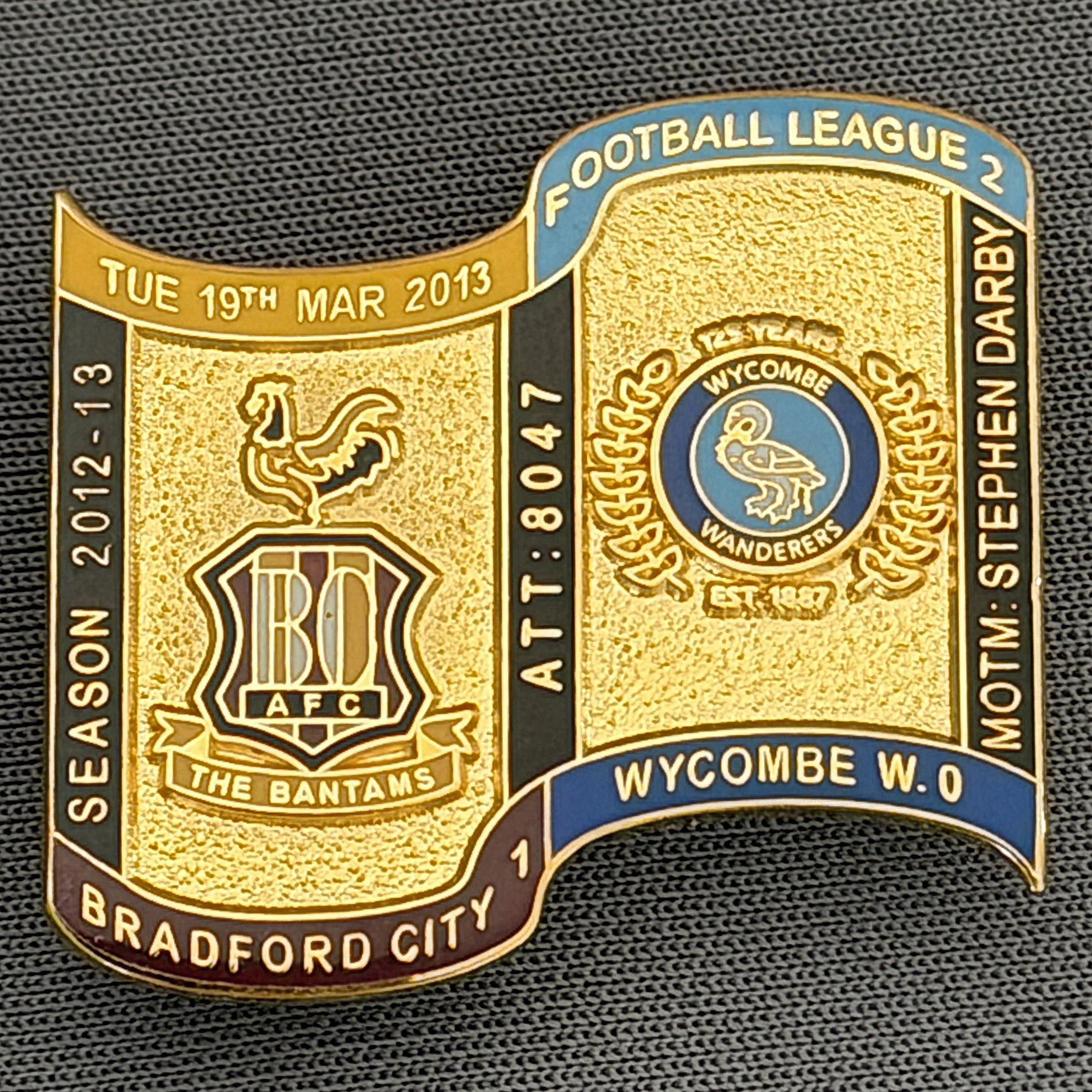 Reference Number: BCFIX133
Size: H 26.9 mm x W 29.2 mm
Pin Type: Brooch Pin
Plating: Gold
Value: £8
Manufacturer: Bradford City Badges
Comments: Bradford City v Wycombe Wanderers 2012/13 Limited Edition 65 Badges