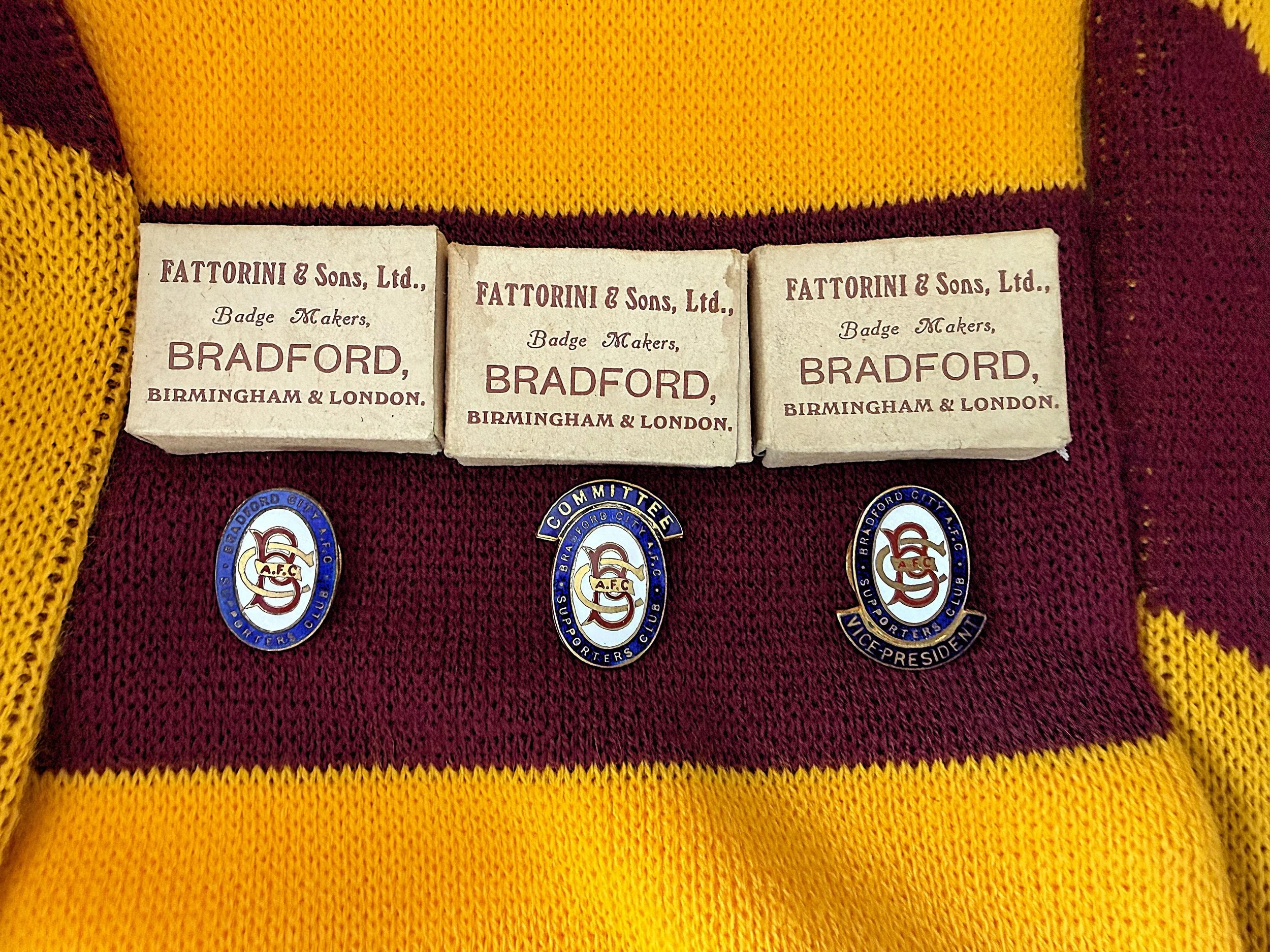 Close-up of vintage matchbox labels and badges on a sports uniform, including the text 'FATTORINI & Sons, Ltd., Badge Makers, BRADFORD, BIRMINGHAM & LONDON' along with the Bradford City AFC logo and badges.