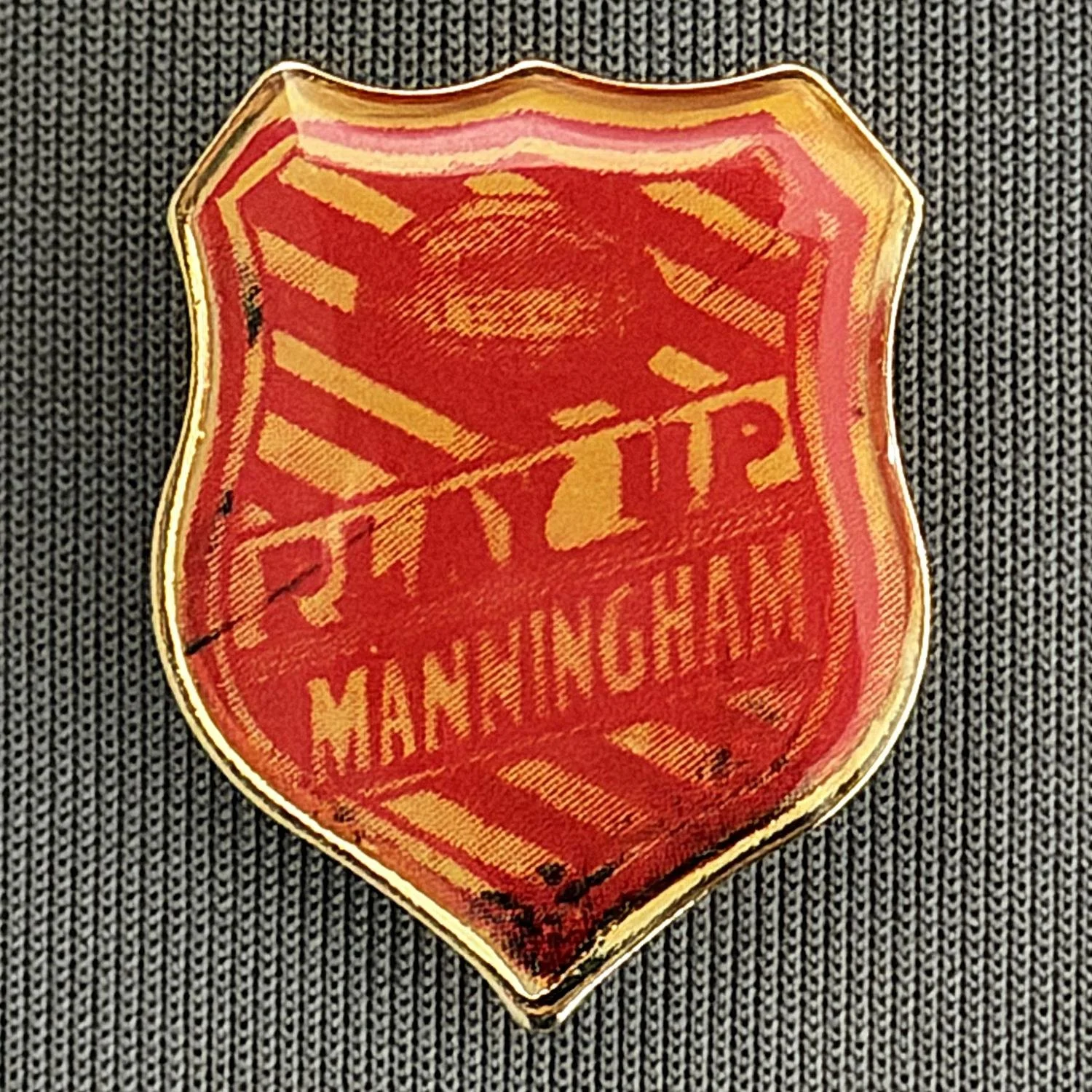 Reference Number: BCUN001
Size: H 25.3 mm x W 20.1 mm
Pin Type: Metal Clutch
Plating: Gold
Value: £8
Manufacturer: Not Known
Comments: Modern Copy of Play Up Manningham Badge, Plastic Dome