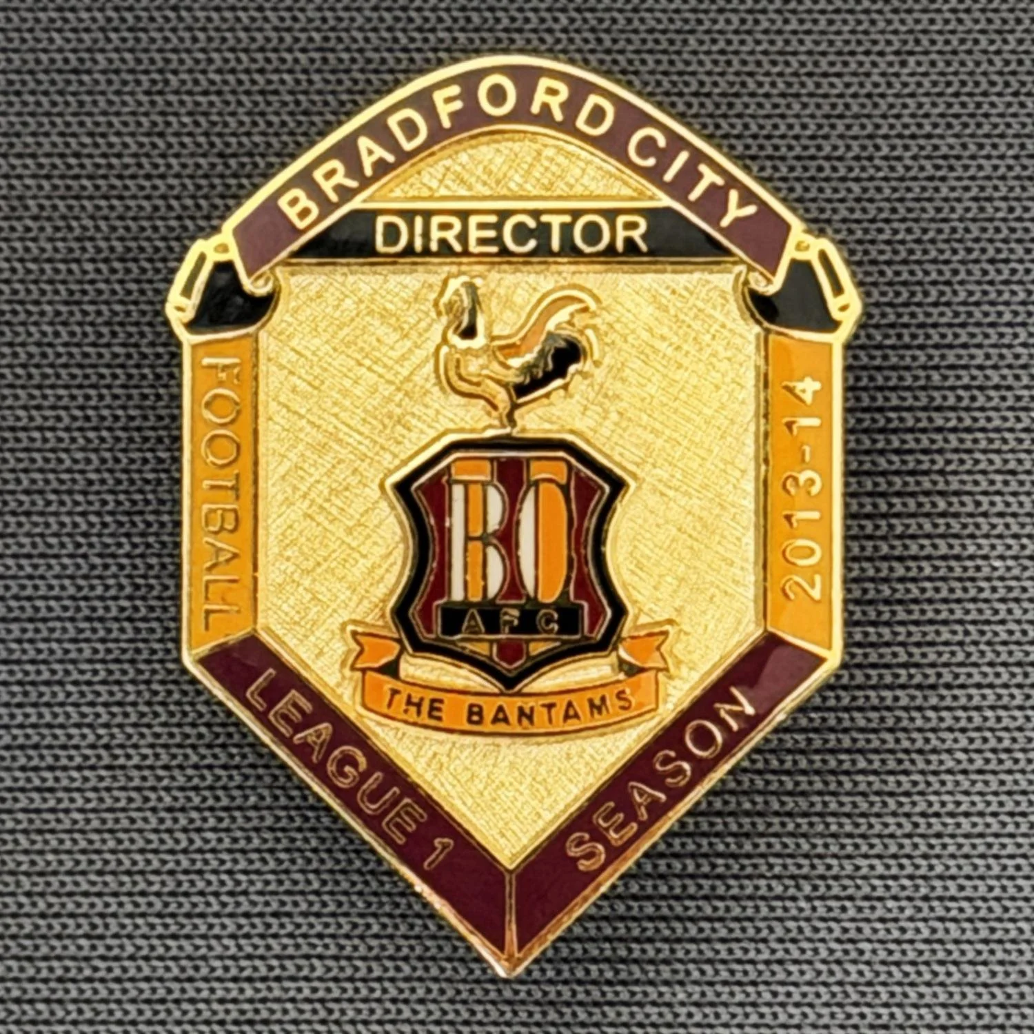 Reference Number: BCDIR002
Size: H 25.5 mm x W 19.5 mm
Pin Type: Brooch Pin
Plating: Gold
Value: £50
Manufacturer: Bradford City Badges
Comments: Worn by Owners Mark Lawn & Julian Rhodes