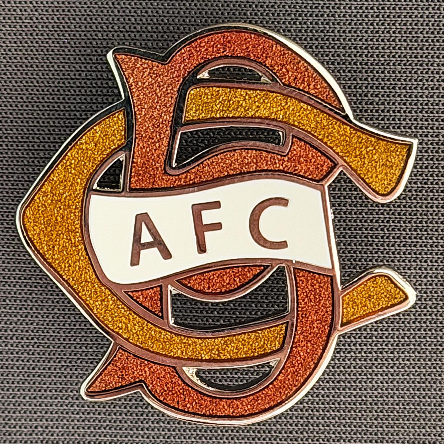 Reference Number: BCC&L060
Size: H 30 mm x 30 mm
Pin Type: Brooch Pin
Plating: Silver
Value: £8
Manufacturer: Paraders
Comments: BCAFC Ayrton Scroll Claret & Amber Cloisonne, White