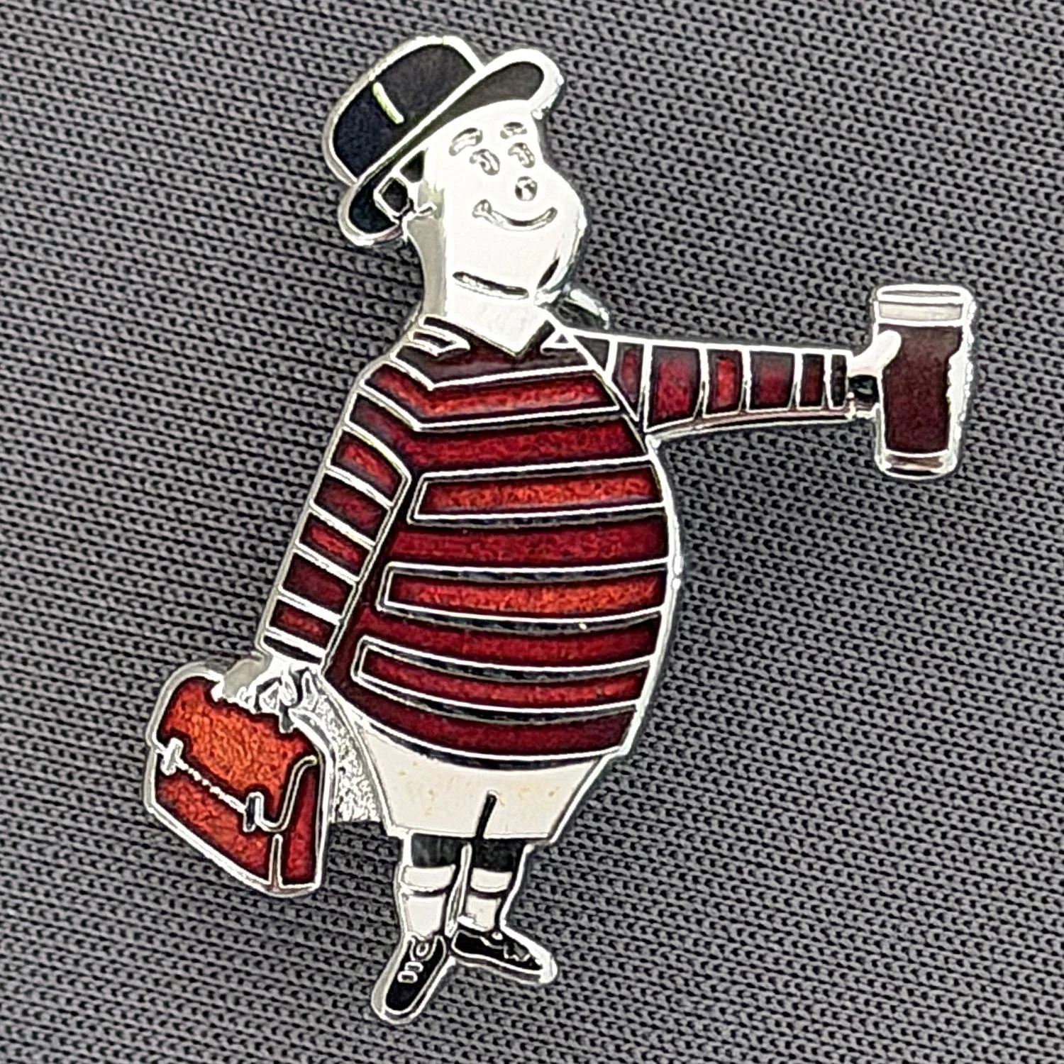 Reference Number: BCGEN093
Size: H 28.8 mm x W 20.9 mm
Pin Type: Brooch Pin
Plating: Silver
Value: £20
Manufacturer: Bradford City Badges
Comments: City Gent Beer Cloisonne, Amber Briefcase. One Off Badge.