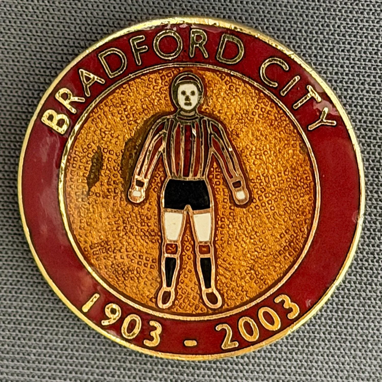 Reference Number: BCEVE83
Size: D 26.2 mm
Pin Type: Brooch Pin
Plating: Gold
Value: £8
Manufacturer: Stewart Roberts
Comments: Bradford City Centenary 1903-2003, 2003 Kit.