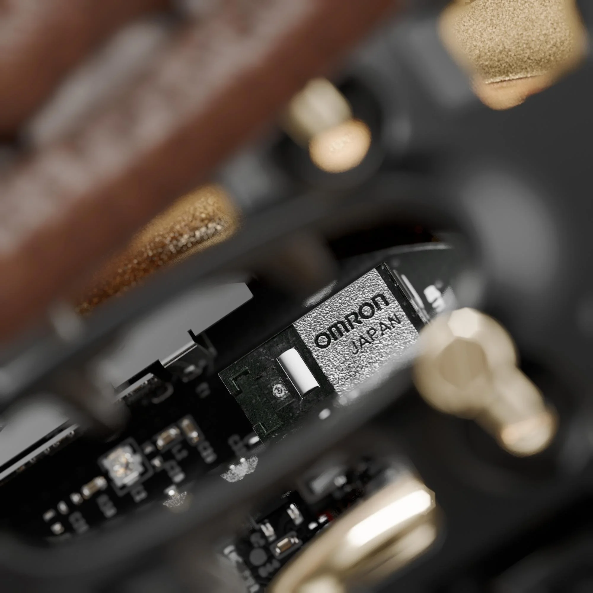 Close-up of a computer graphics card showing the brand 'Omron Japan' on a component.