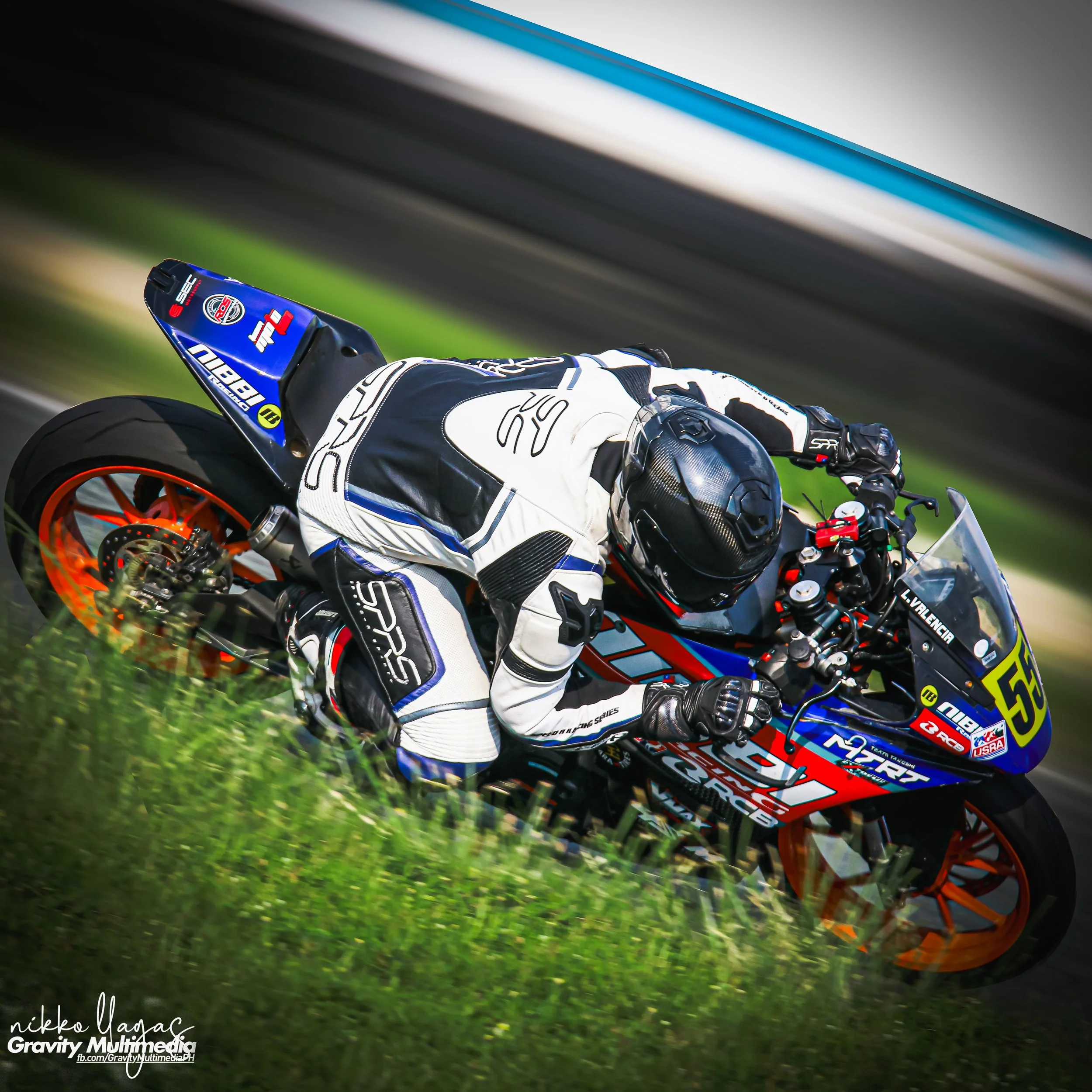 Lawrence Valencia leaning into a turn on a race track on KTM RC390 at Clark International speedway