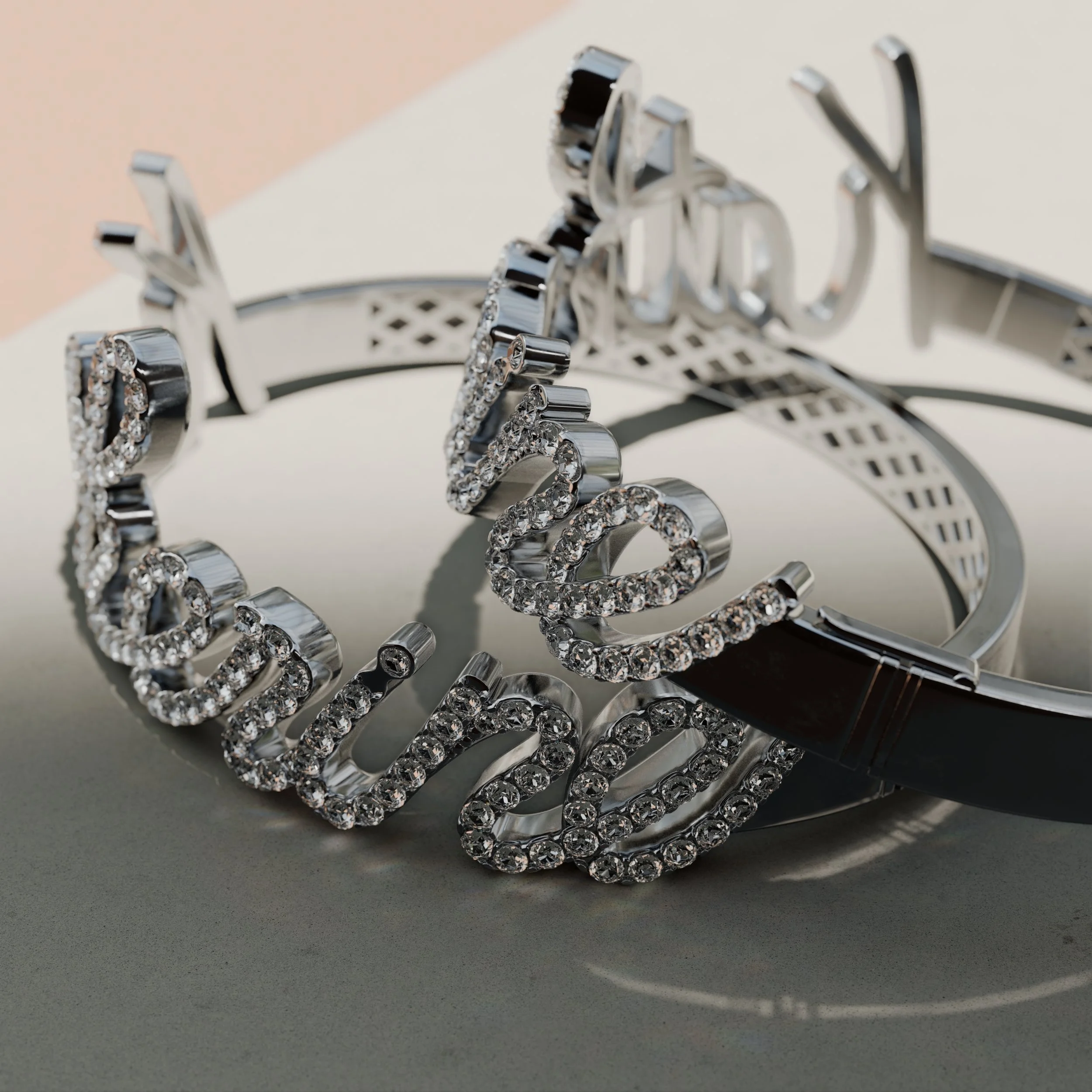 A silver bracelet with the word "love" spelled out in cursive, encrusted with small clear rhinestones, placed on a flat surface.