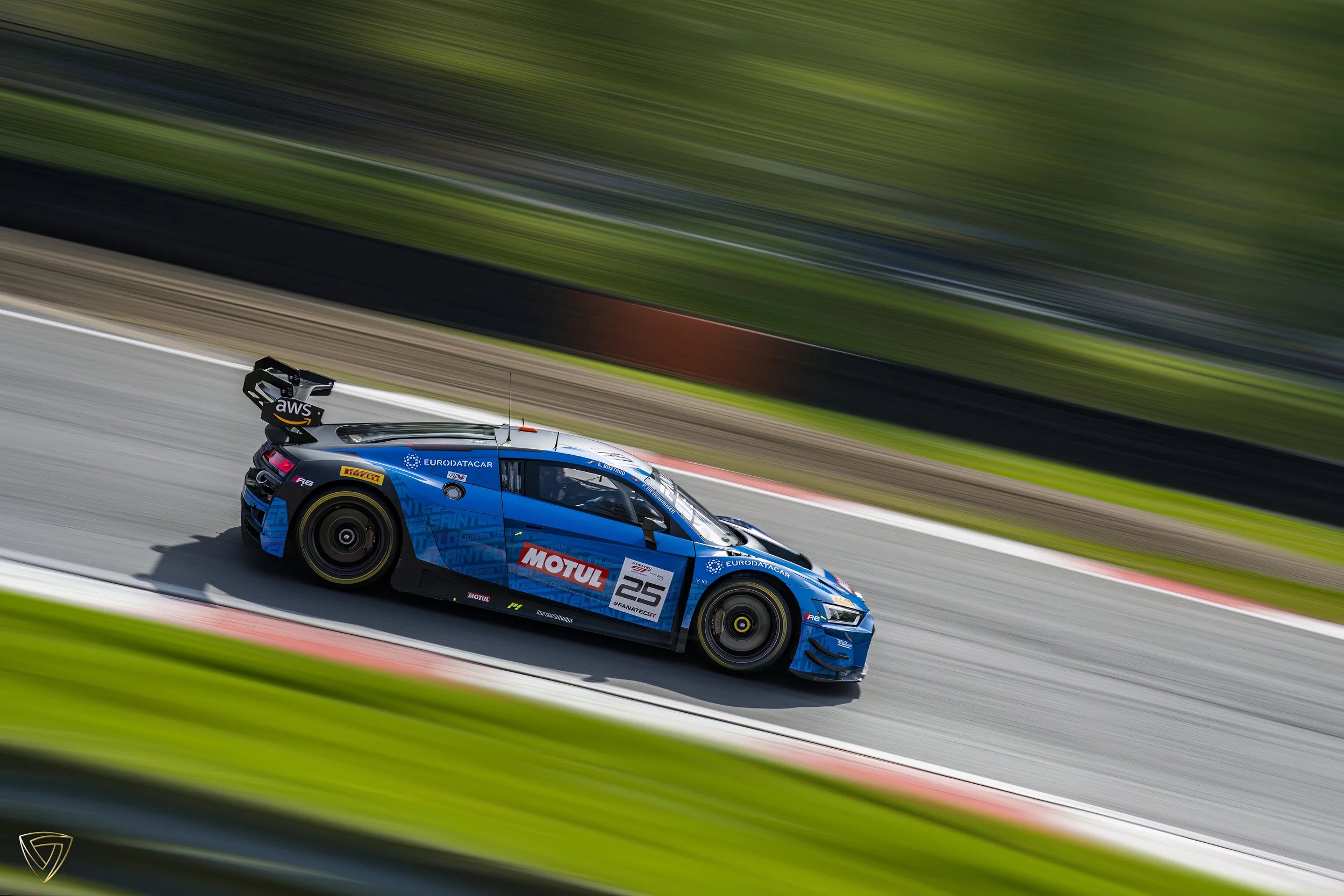 A blue racing car speeding on a track with motion blur background.