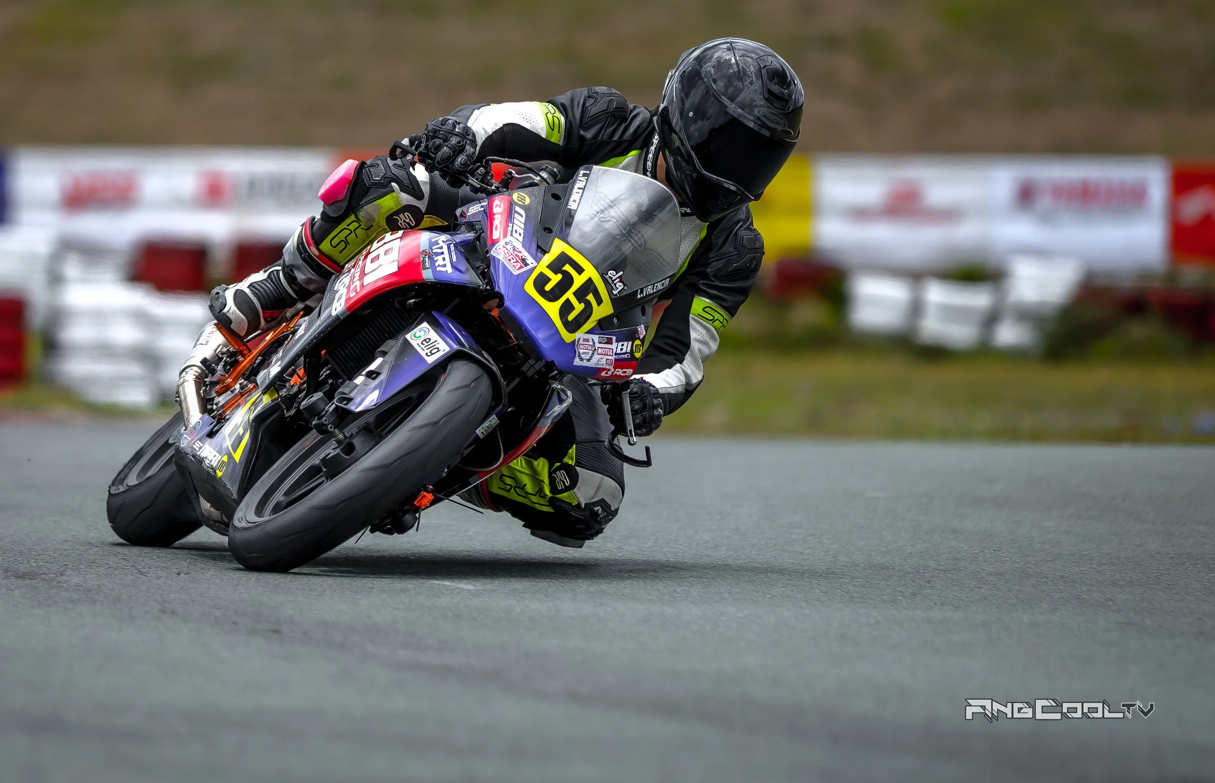 Lawrence Valencia racer leaning into a turn on a racetrack, wearing a Caberg helmet and SPRS gear, with the number 55 during IRGP XIIV 2021