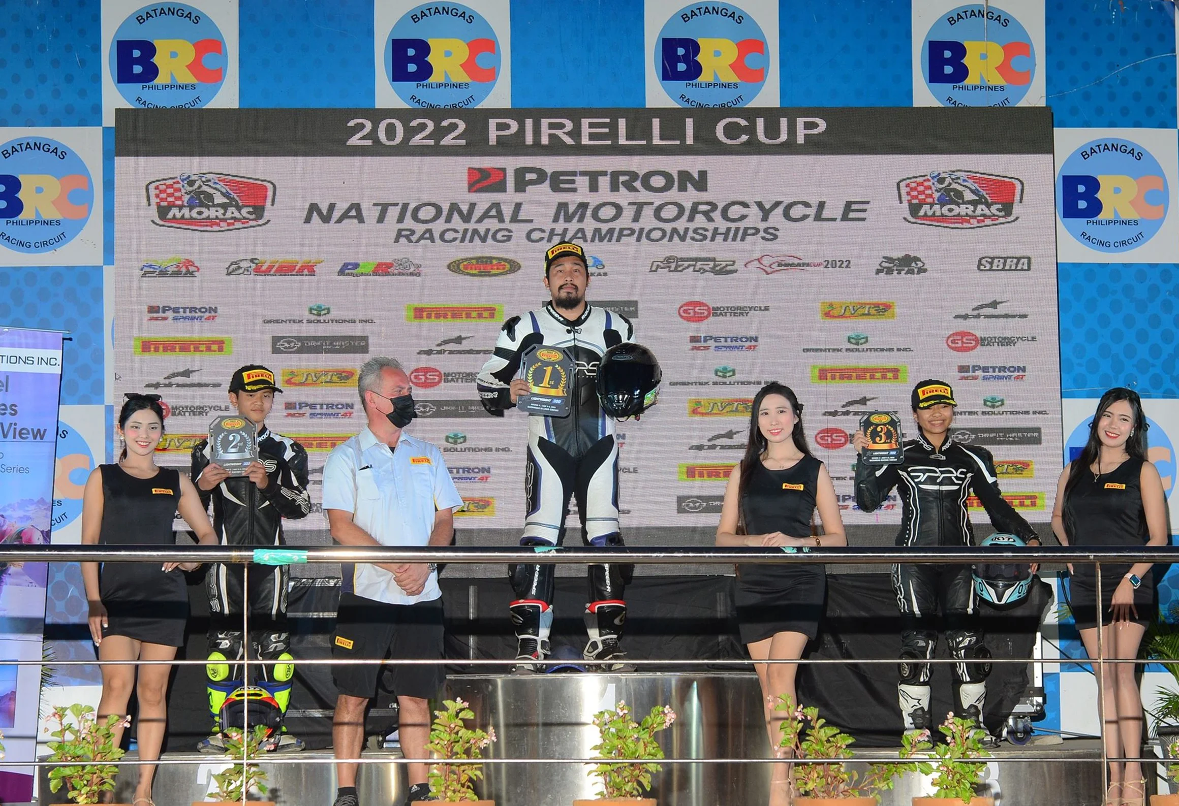Lawrence Valencia winner  at Pirelli Cup event with large backdrop displaying event name and sponsors in the Philippines.