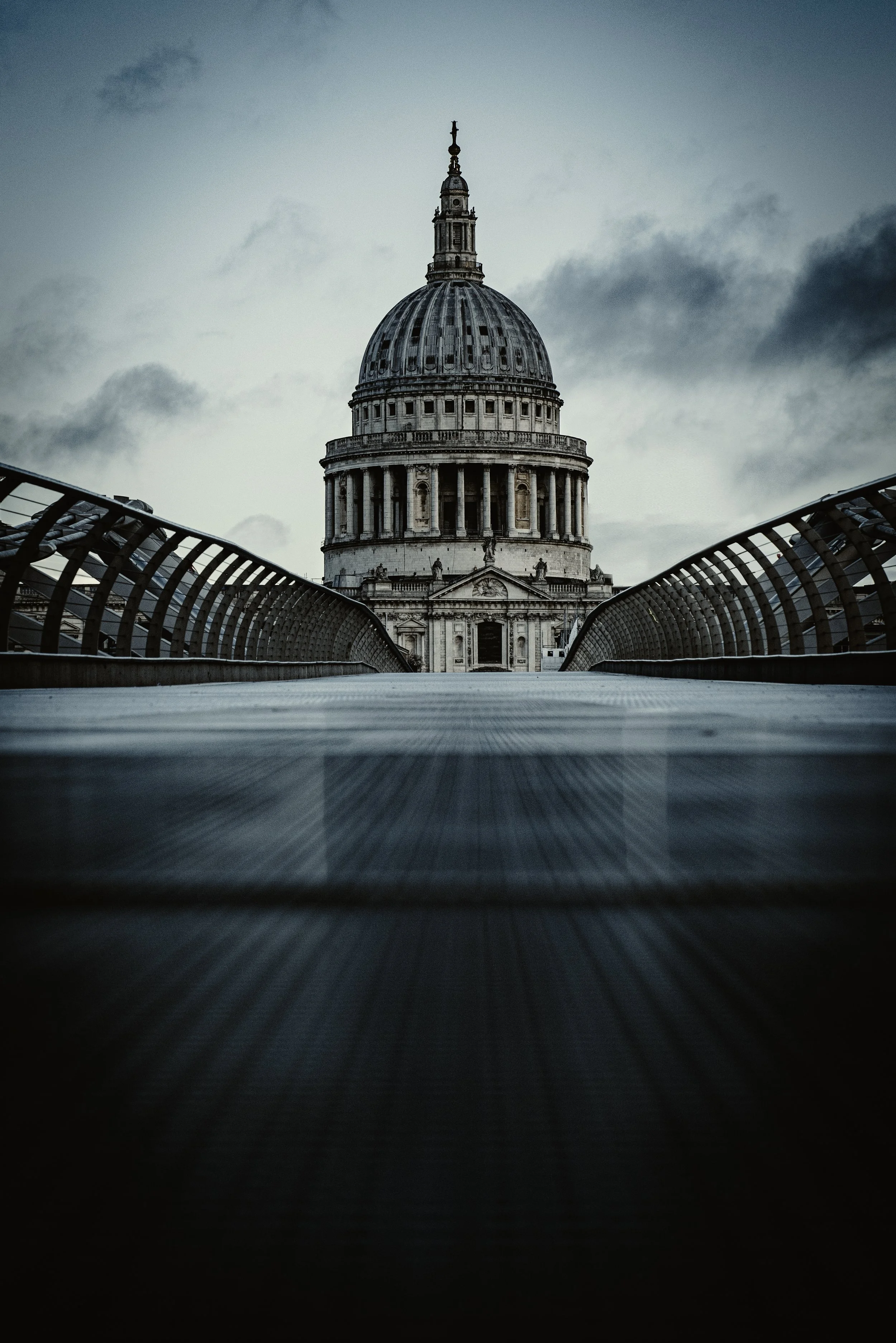 View of St. Paul's Cathedral in London from a low-angle perspective on the Millennium Bridge.