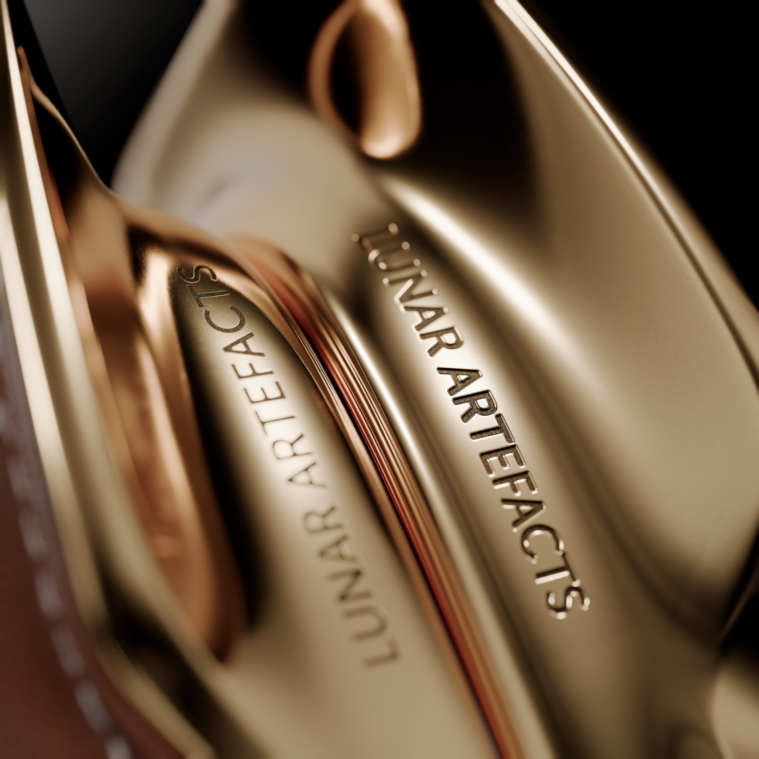 Close-up of a metallic object with engraved text that says 'LUNAR ARTIFACTS' and 'ARTIFACTS' in a sleek, reflective, gold-colored surface.