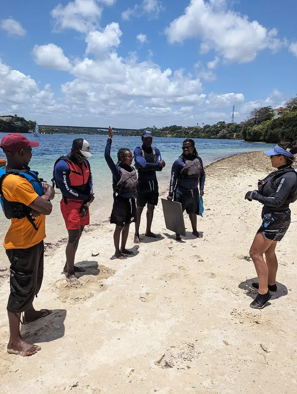 Group of watersports learners on a sunny beach in Kenya.