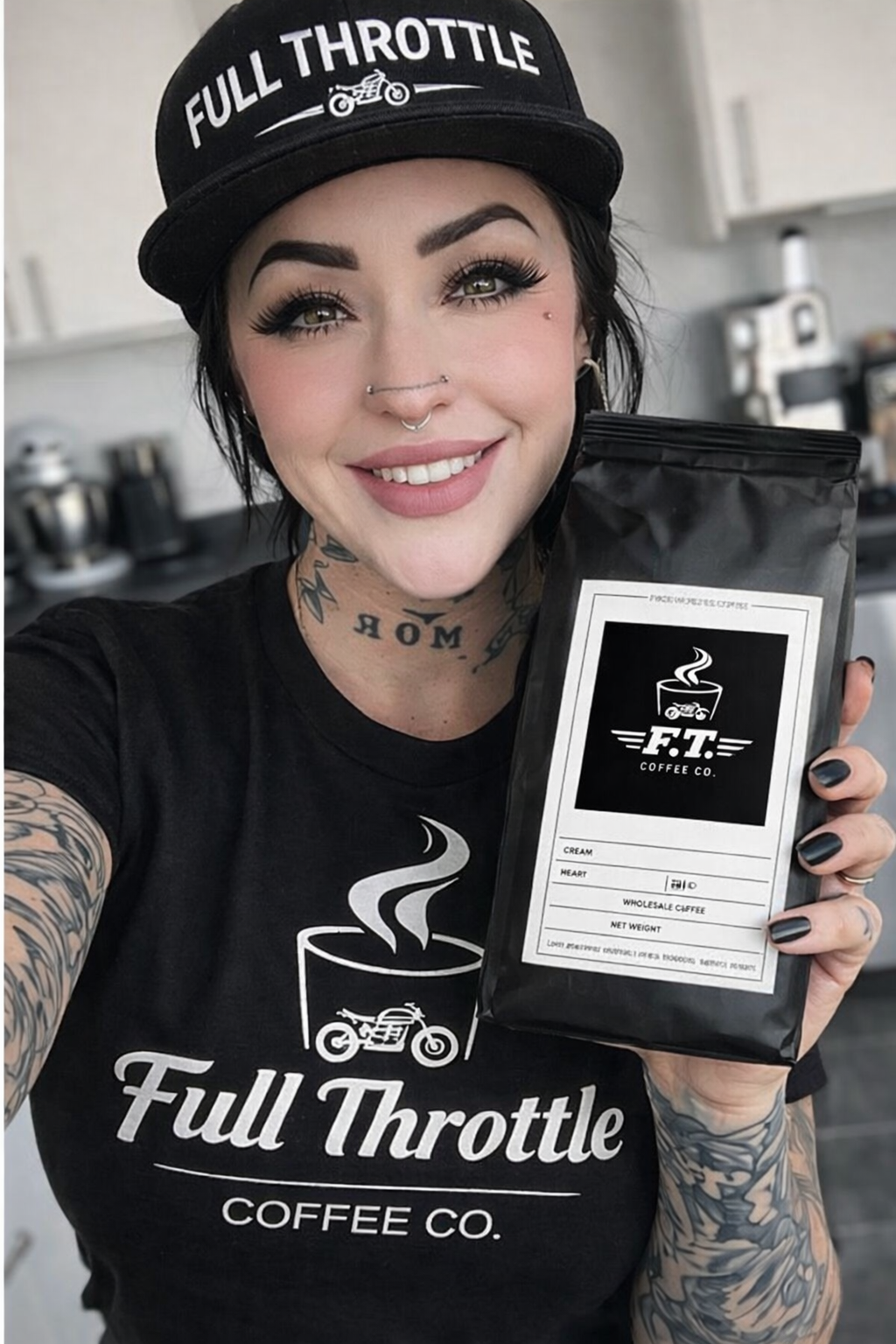 A smiling woman with tattoos, wearing a black Full Throttle Coffee Co. T-shirt and a black cap that says 'Full Throttle' with a motorcycle graphic. She is holding a bag of coffee from the same company, which has a black and white label. The background appears to be a coffee shop or kitchen.