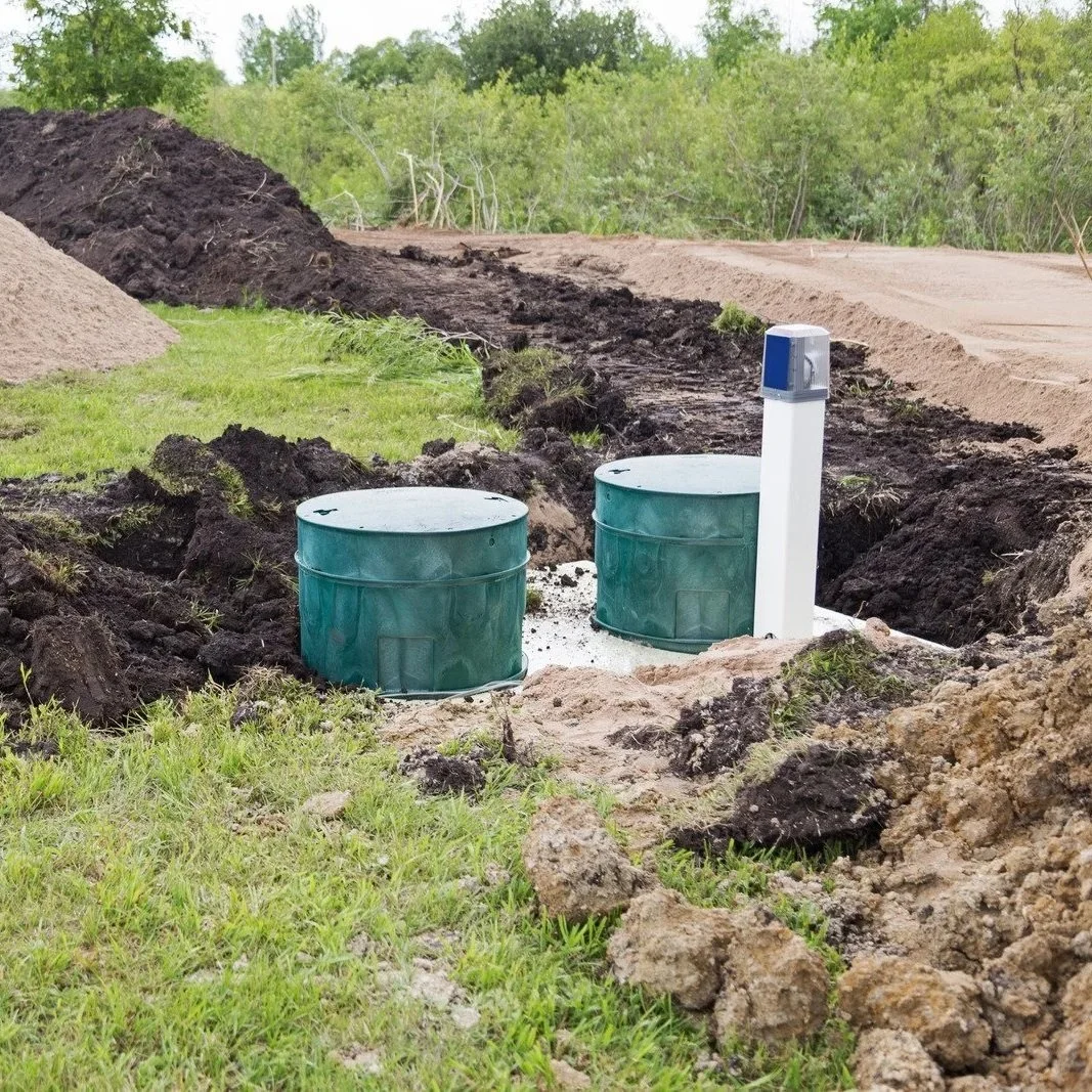 Septic system access risers and vent components at campground wastewater site prepared to handle increased sewage demand during peak camping season.