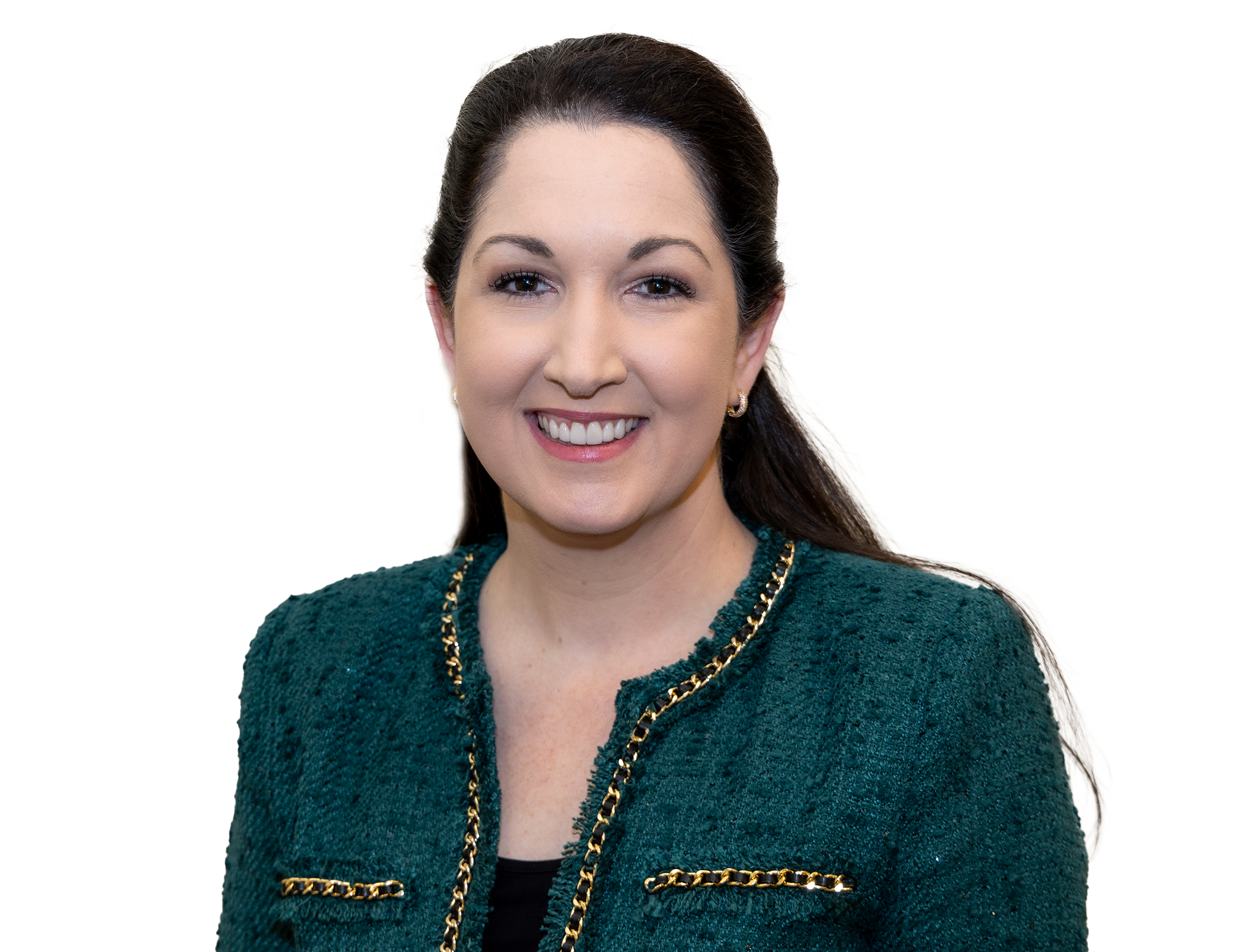 Headshot of a woman with dark brown hair in a ponytail, wearing a green textured blazer with gold chain accents, smiling with white teeth, against a plain white background.