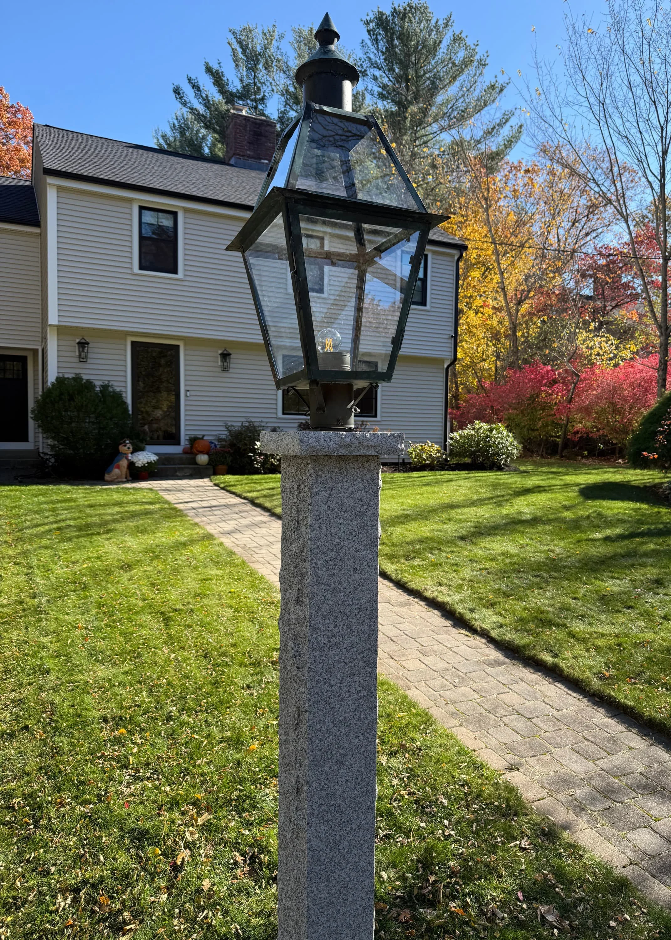 granite light post with black lantern on top