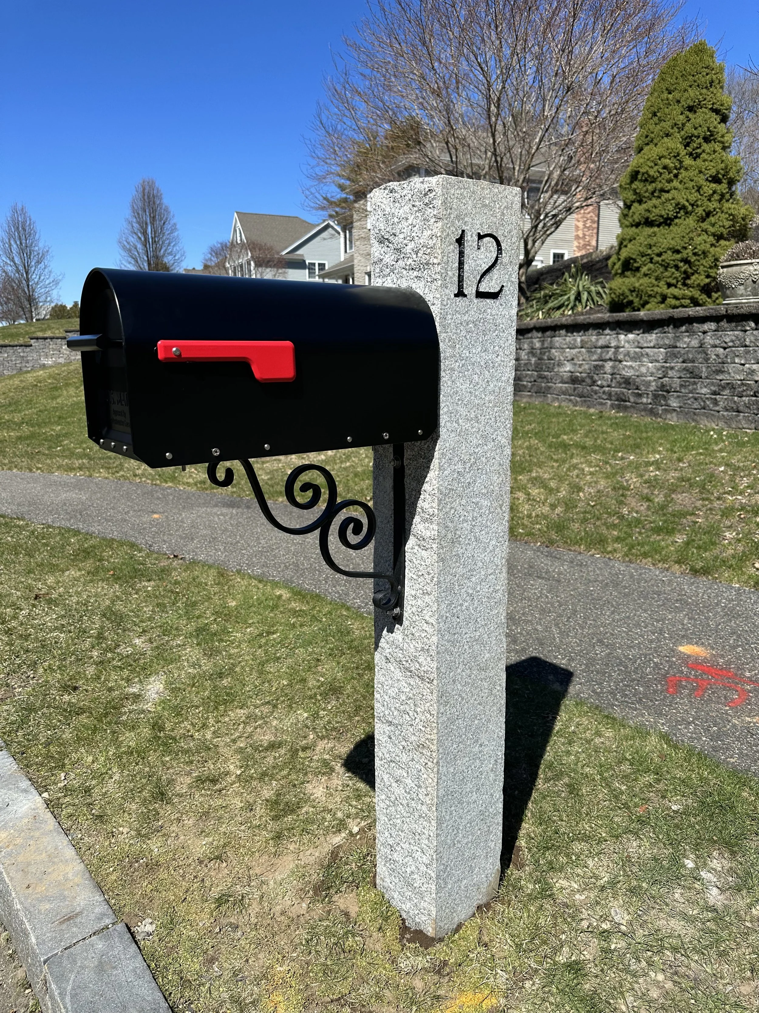 granite post with number 12 engraved, natural cap, black mailbox, double scroll bracket