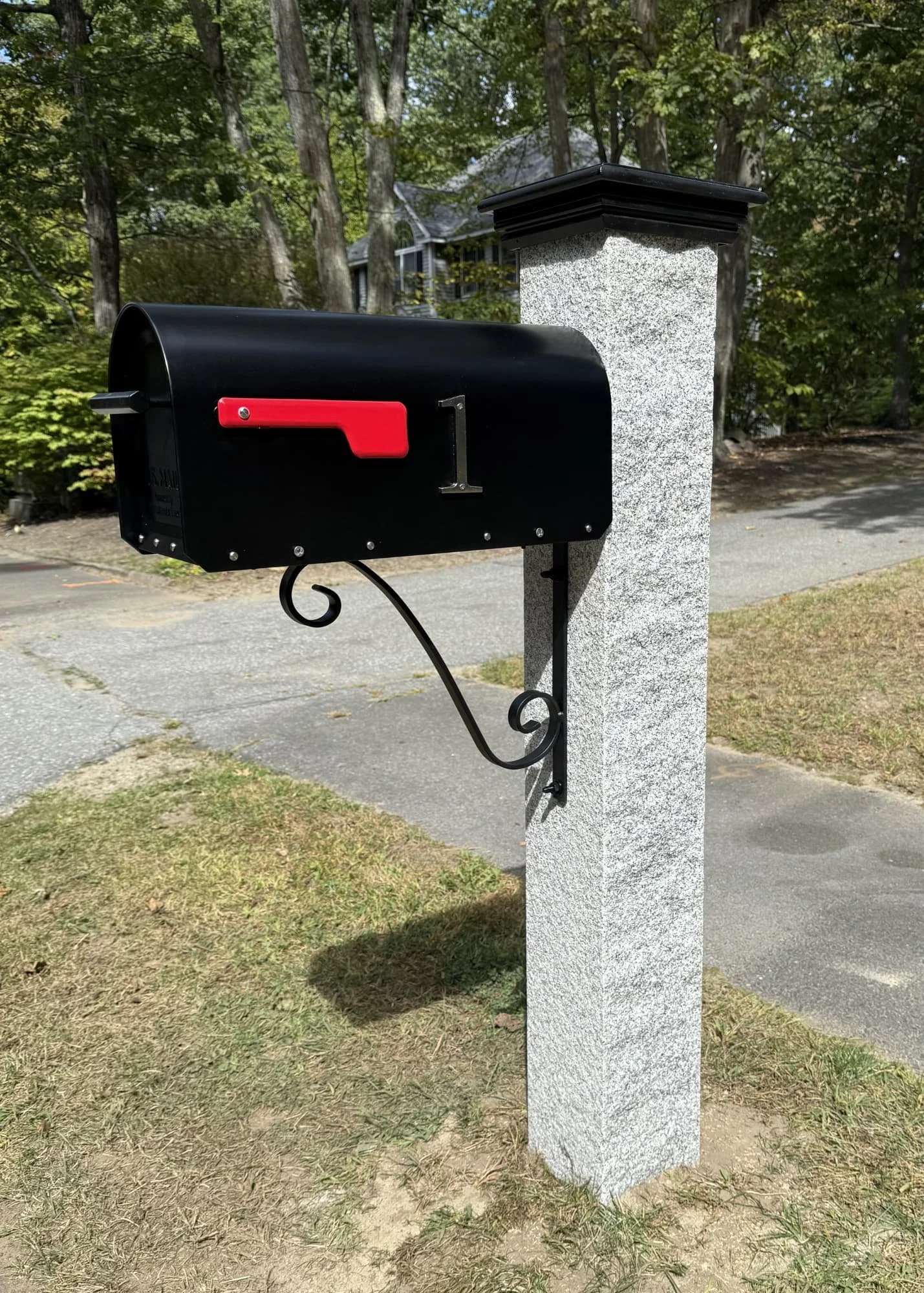 granite post, black AZEK cap, black mailbox, single scroll bracket