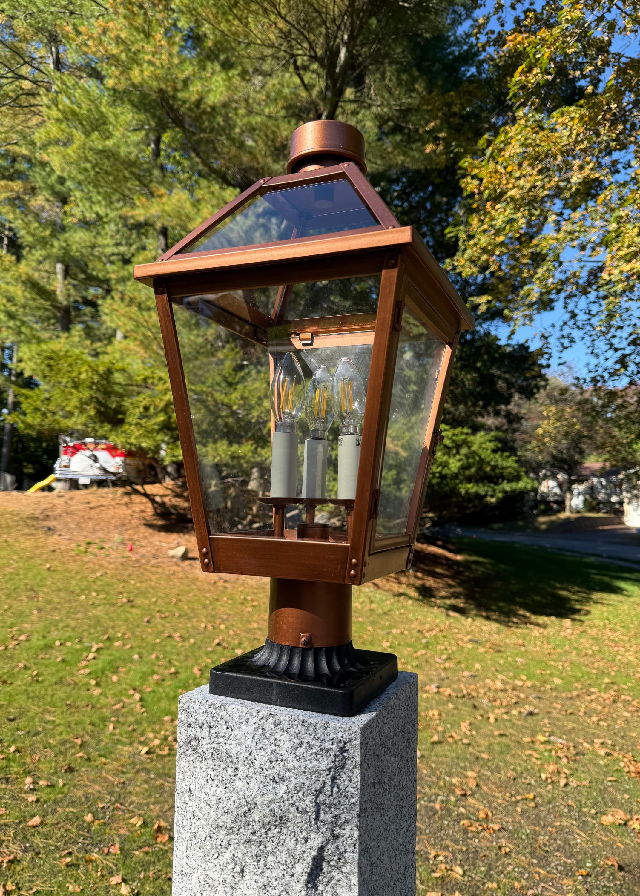 close-up of copper lantern on a granite post
