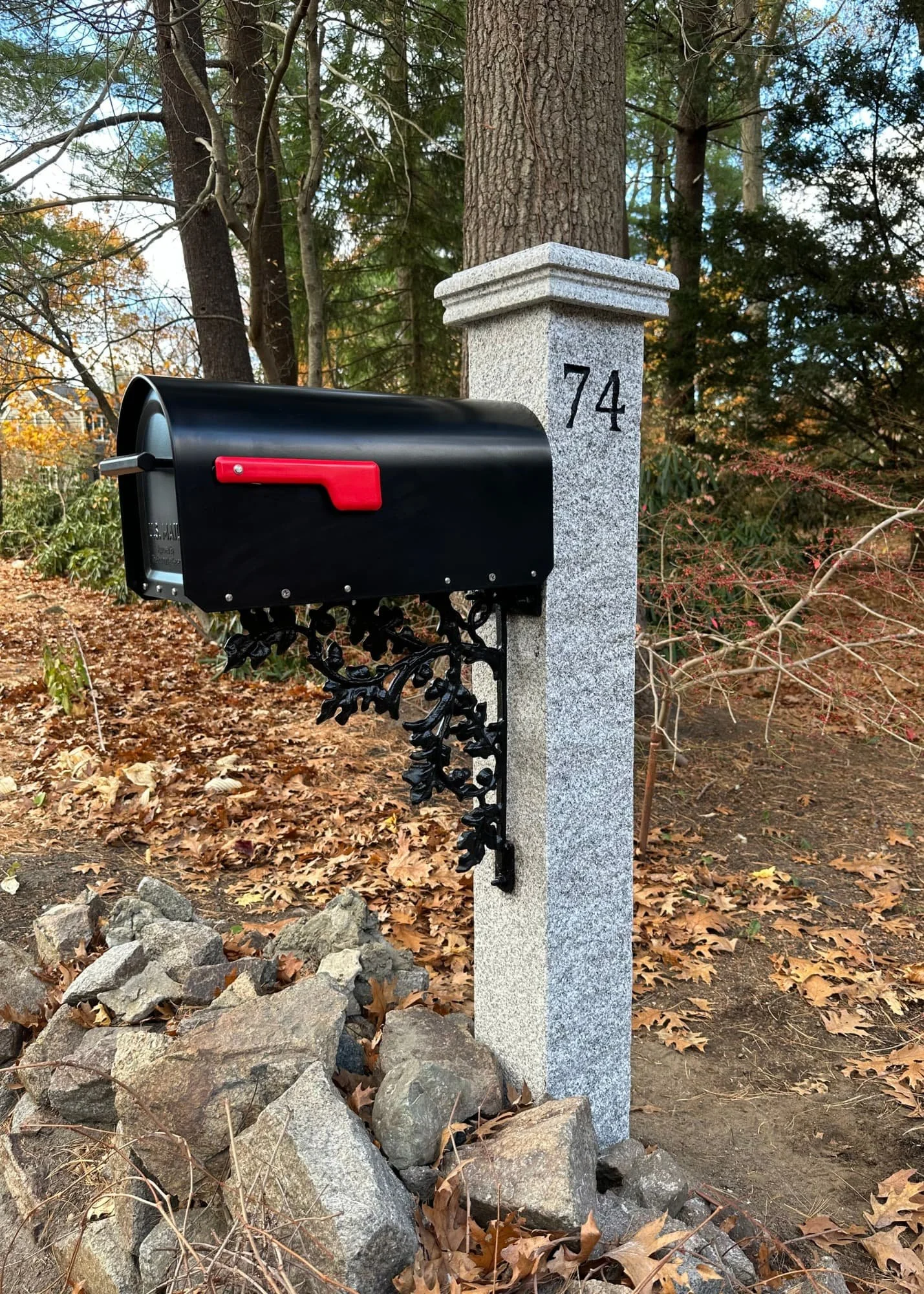 granite post, white AZEK cap, black mailbox, cast iron oak bracket