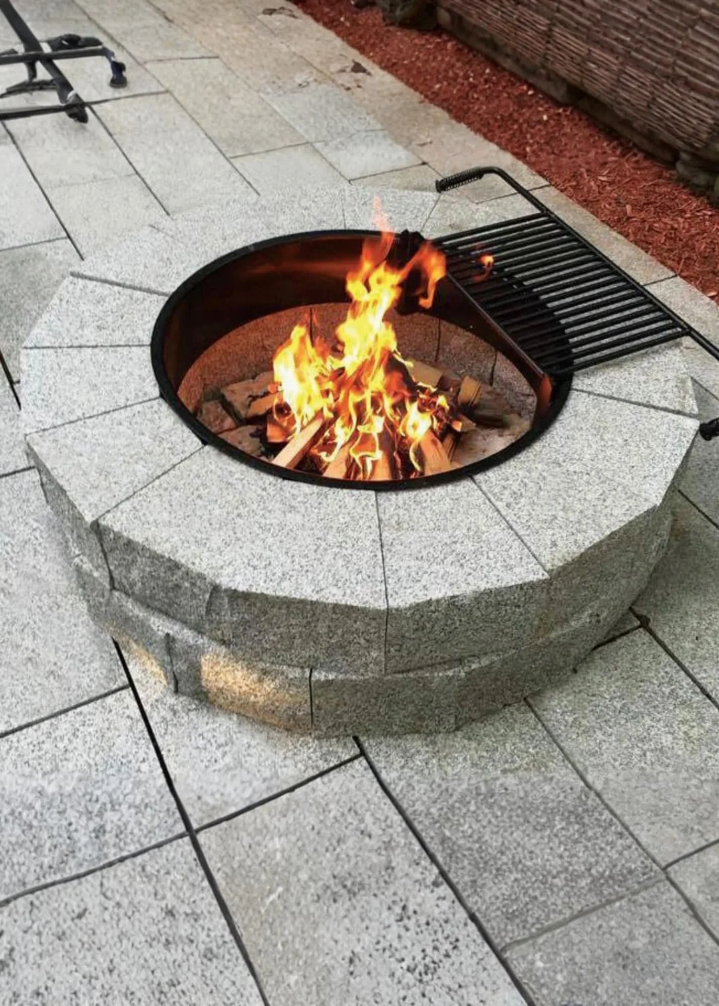 granite fire pit with a fire going