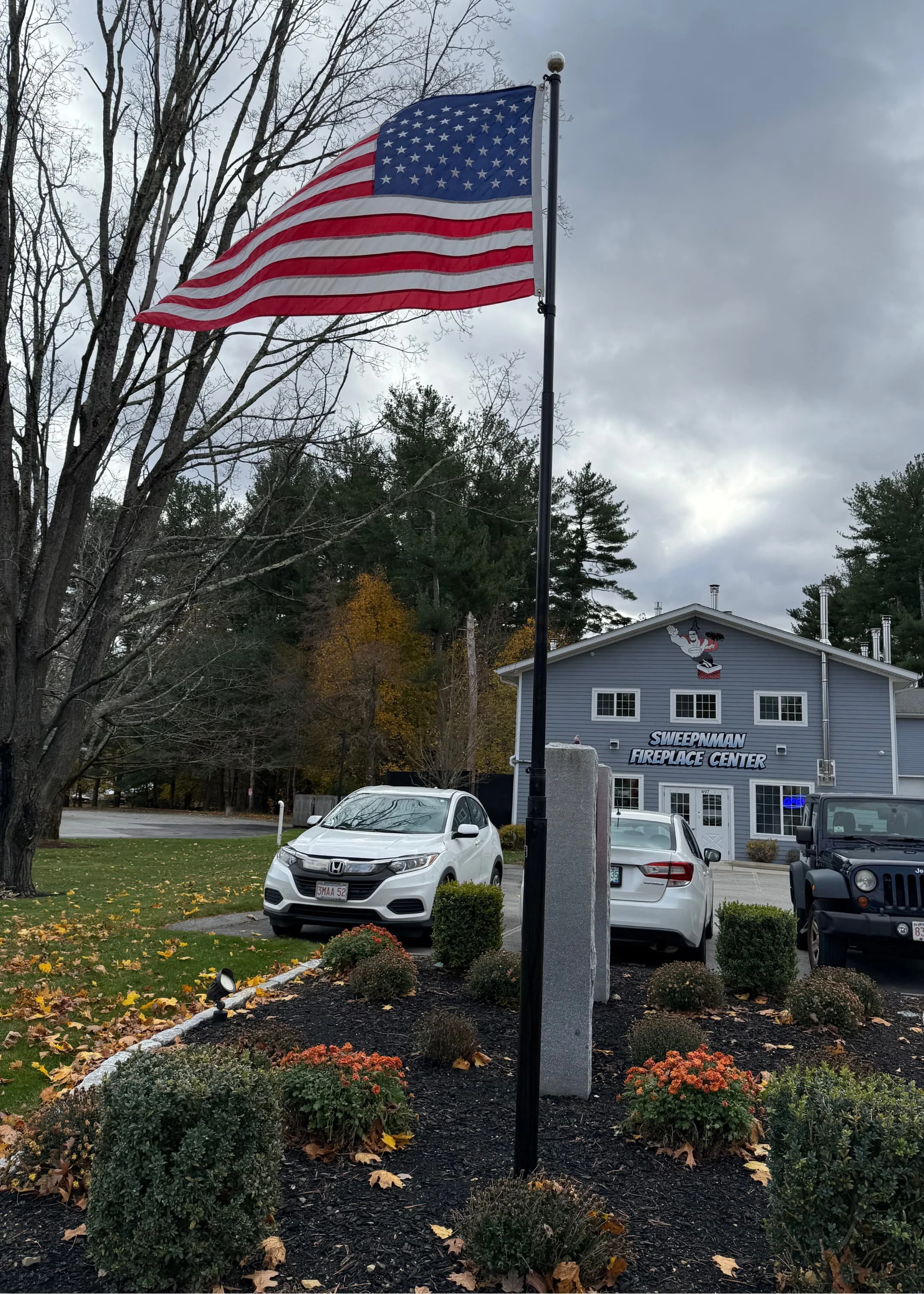 black flag pole flying the American flag
