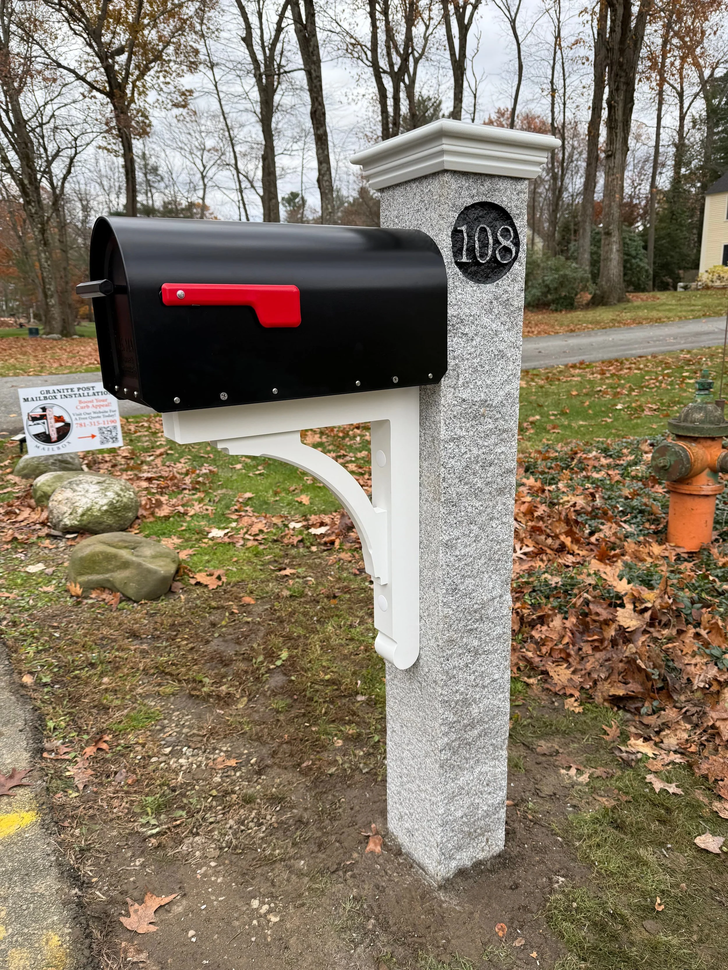 granite post, white AZEK post cap, black mailbox, white AZEK bracket