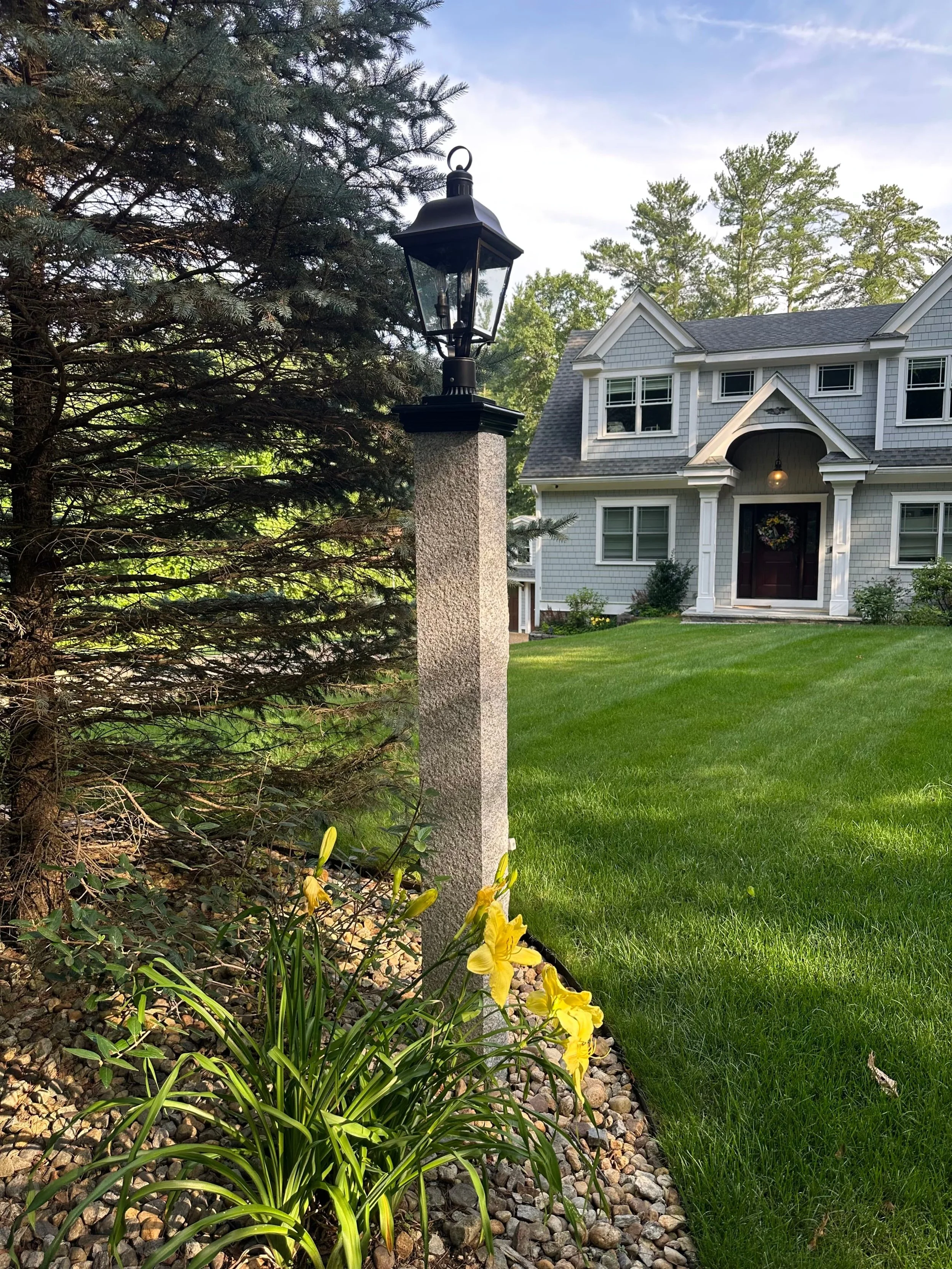 granite light post with black lantern on top