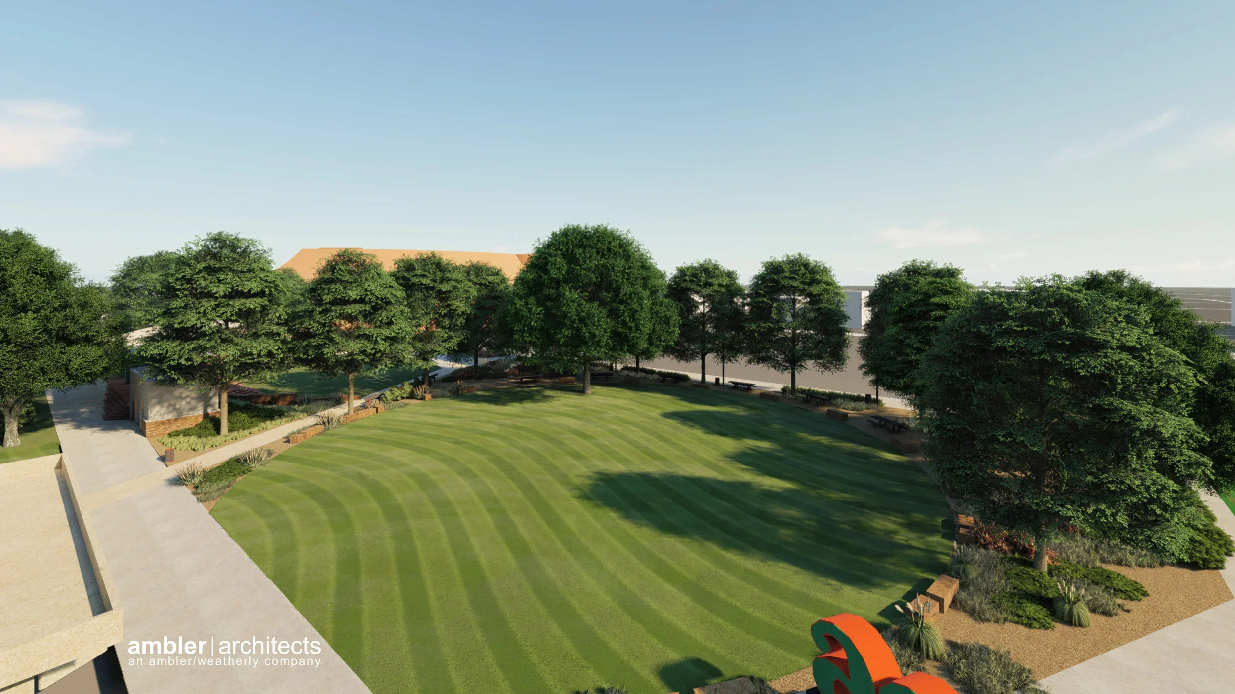 A landscaped park with a grassy oval lawn, surrounded by tall green trees, benches, and paved walkways.