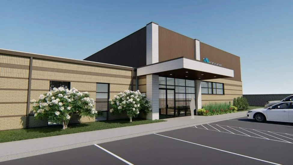 Rendering of a modern commercial building with a parking lot, trees, and landscaping.