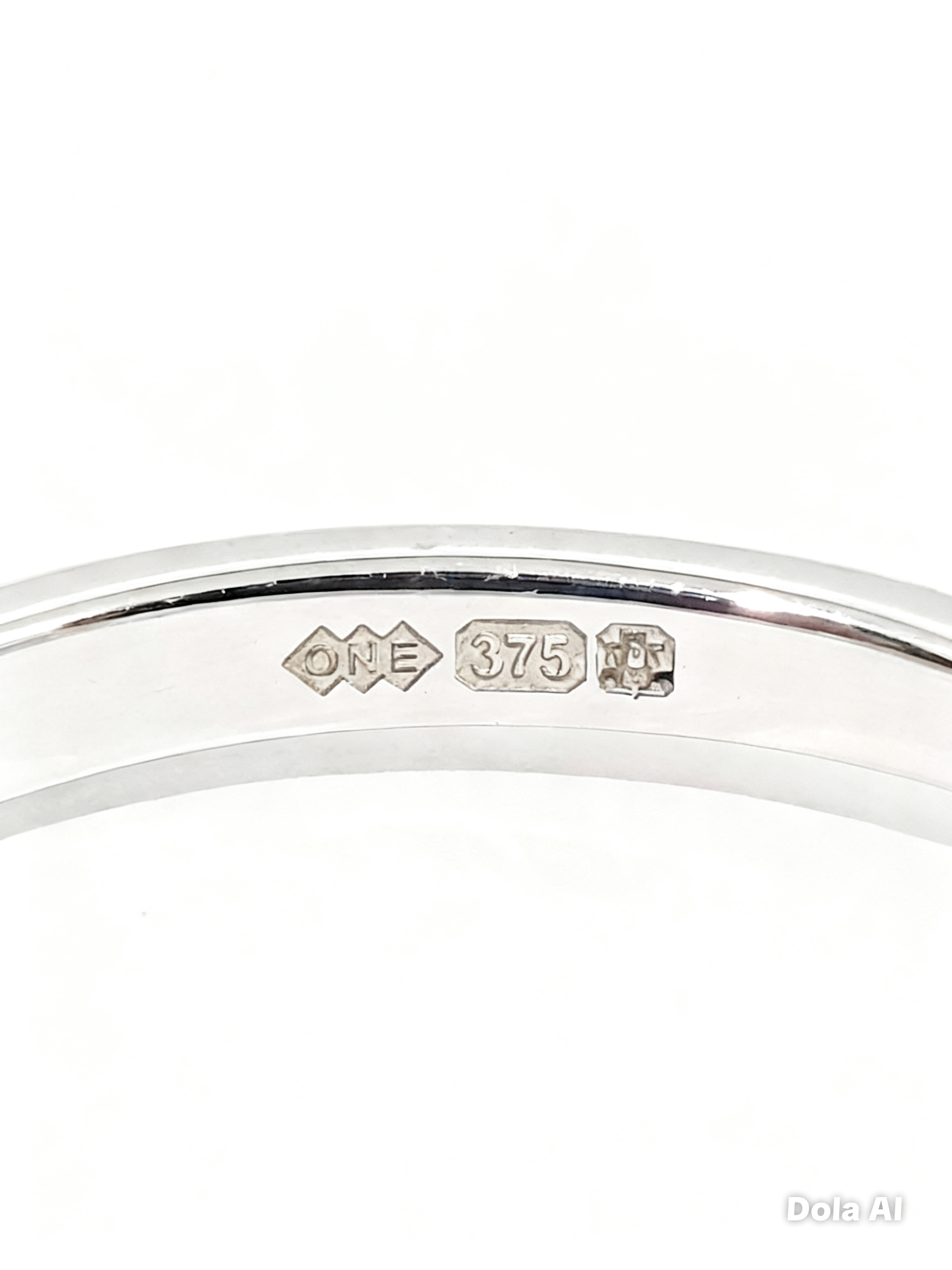 Macro photograph of 1V1 LONDON signature 9ct solid gold ring interior featuring the official Edinburgh Assay Office Castle hallmark, 375 purity stamp, and ONE sponsor mark for legal verification.