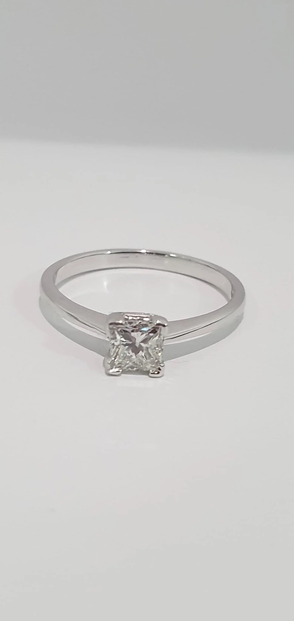 A bespoke princess cut engagement ring. GIA certified diamond. white gold. 9ct.