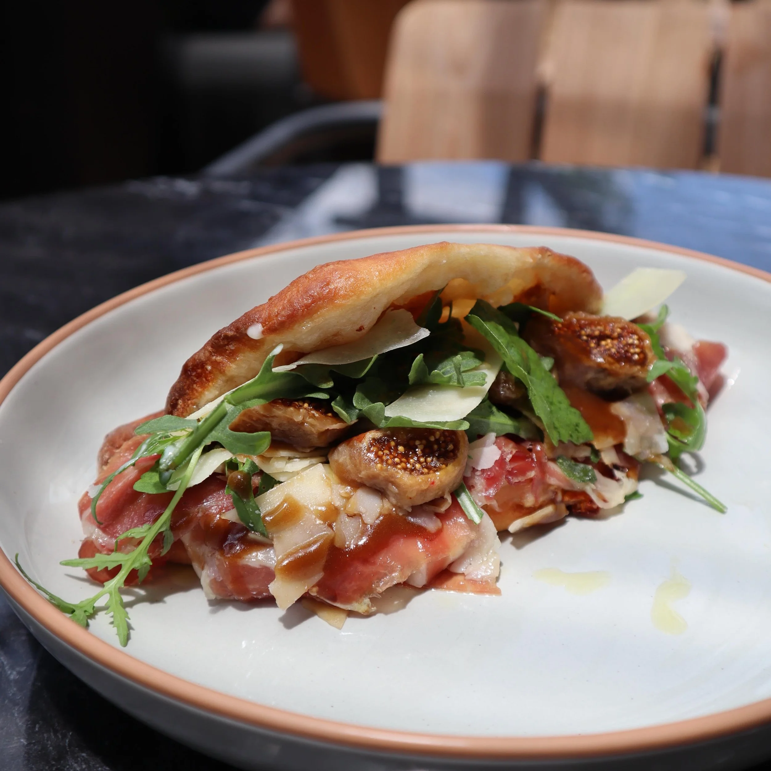 now spinning - fig &amp; prosciutto panino 

An ode to Mediterranean summer //
24-hour fermented pizza dough baked fresh and folded Roman-style, filled with smoked provolone, lemon aioli, 24-month-aged prosciutto di Parma, organic figs, fresh arugula
