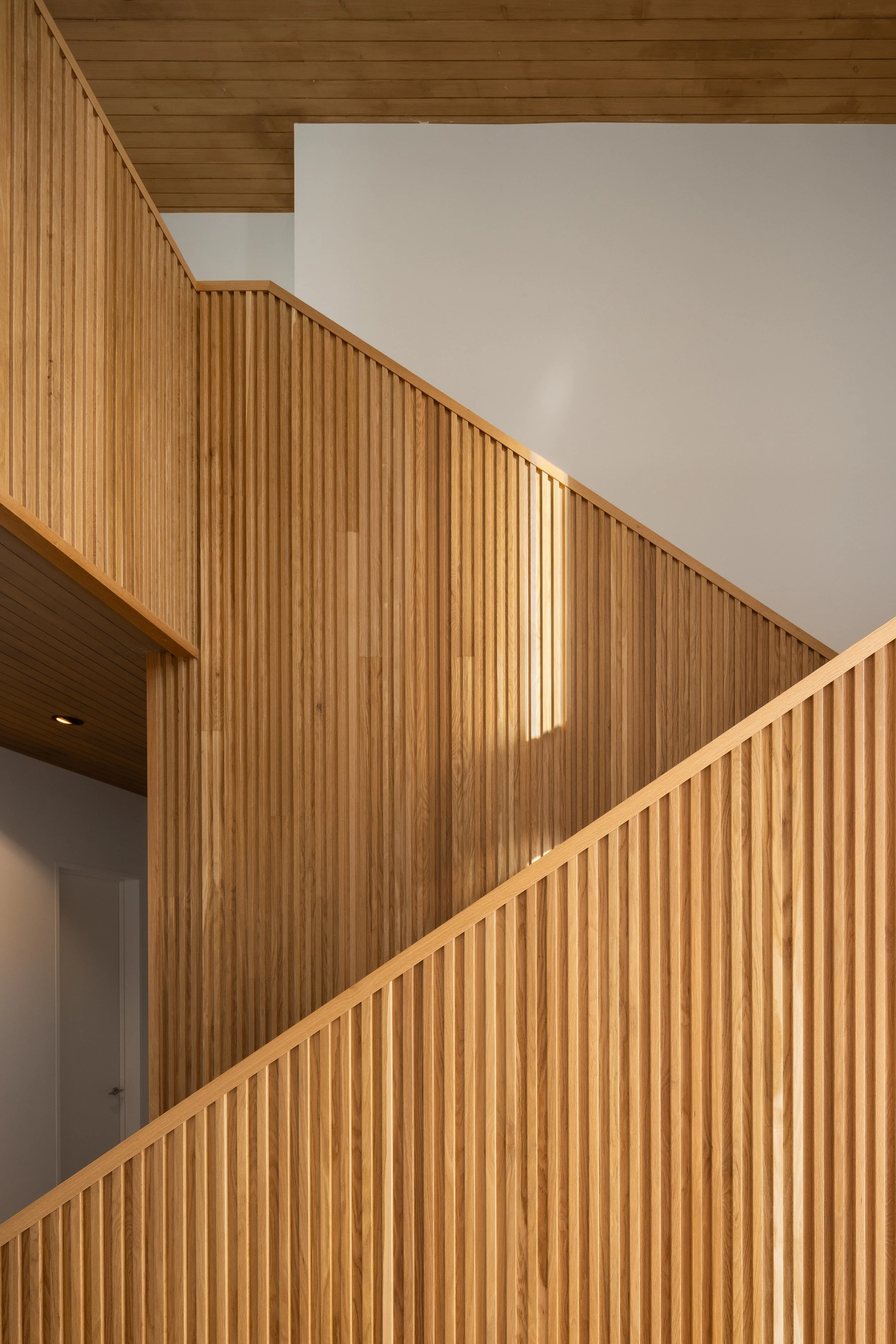 Split Timber House in Jackson, Wyoming. Interior view of wooden staircase.